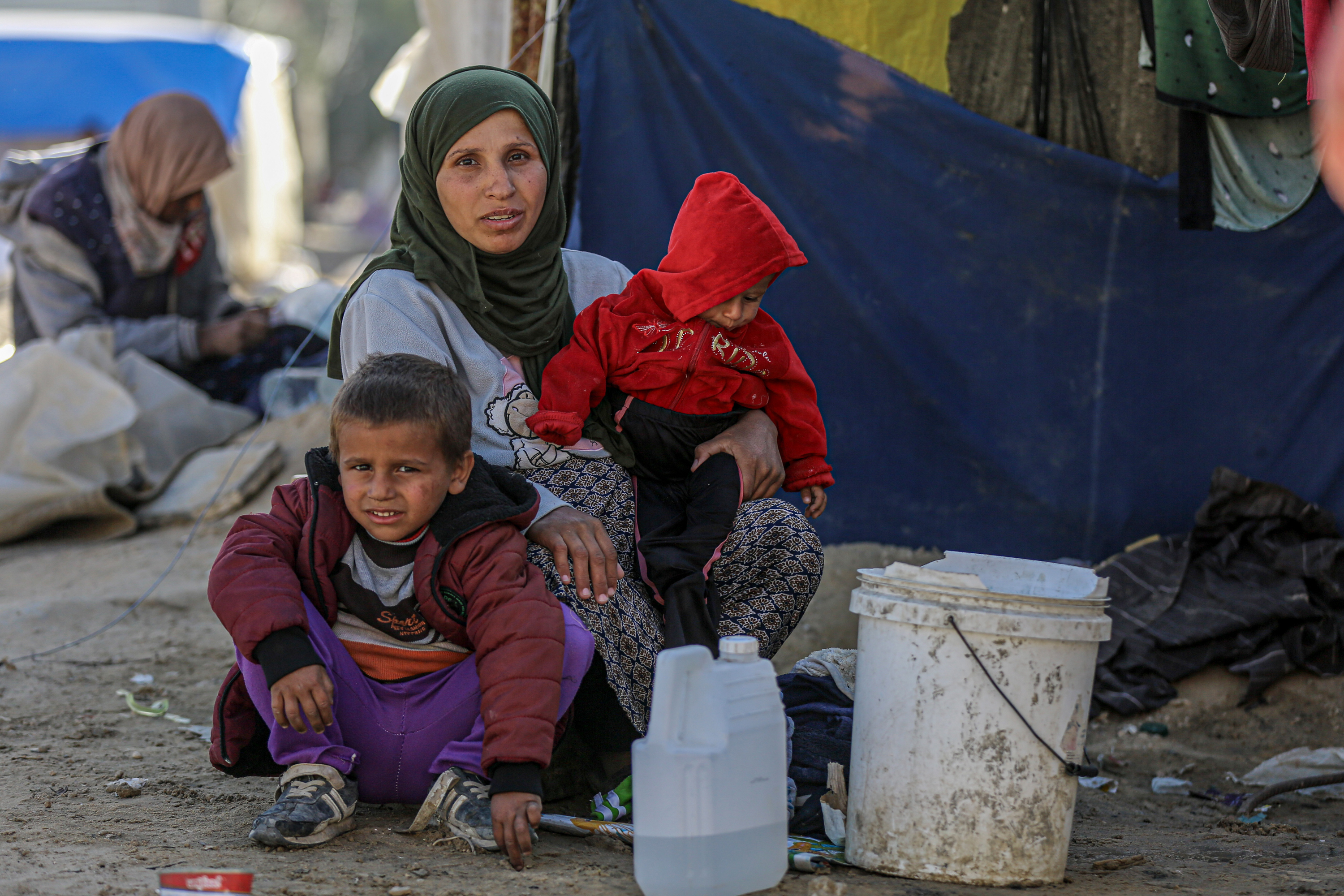 Etemad Assaf, 29, pictured with her two children, is eight months pregnant and is fearful of giving birth in these conditions
