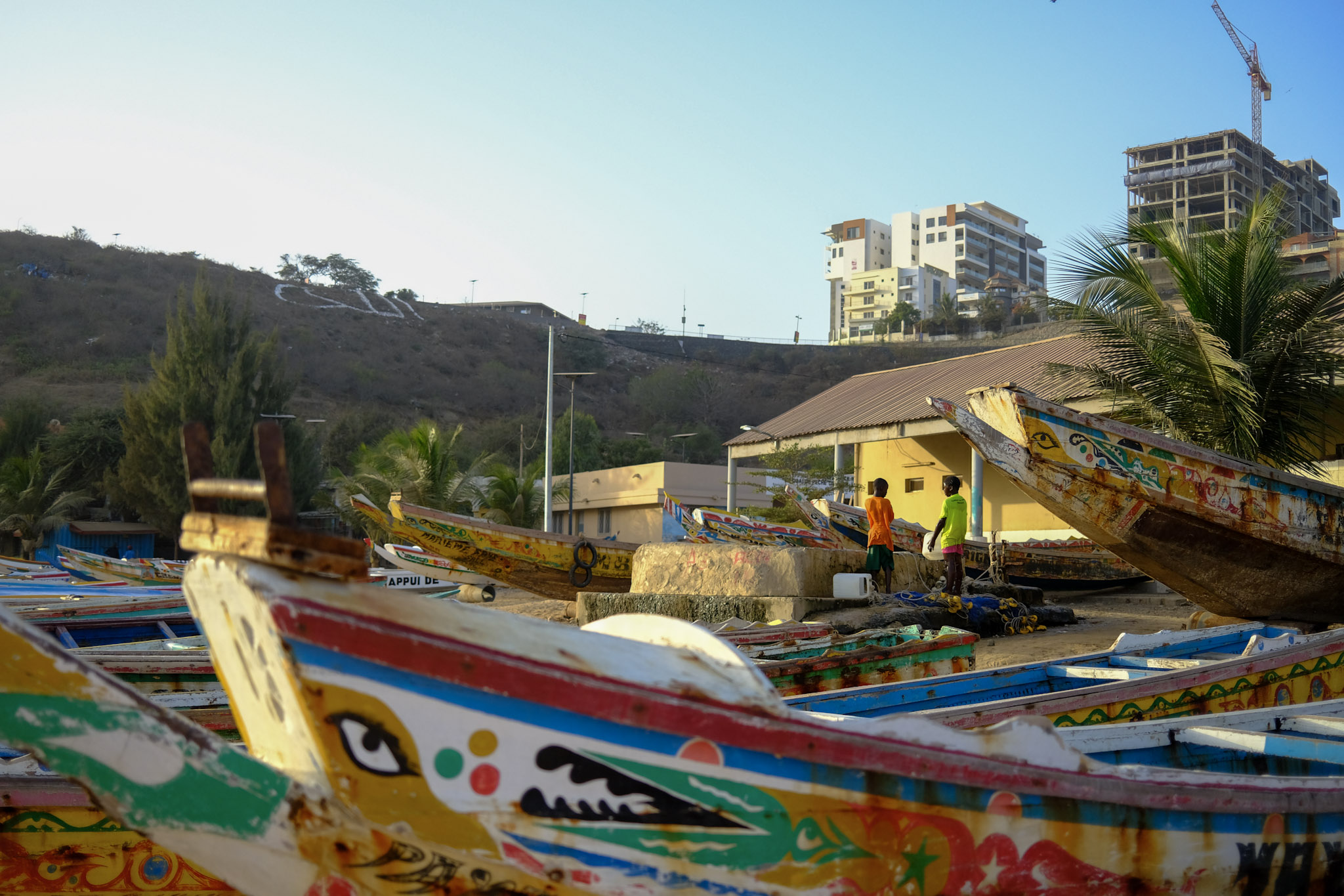 Traditional fishing canoes, called pirogues, are parked at the Ouakam beach