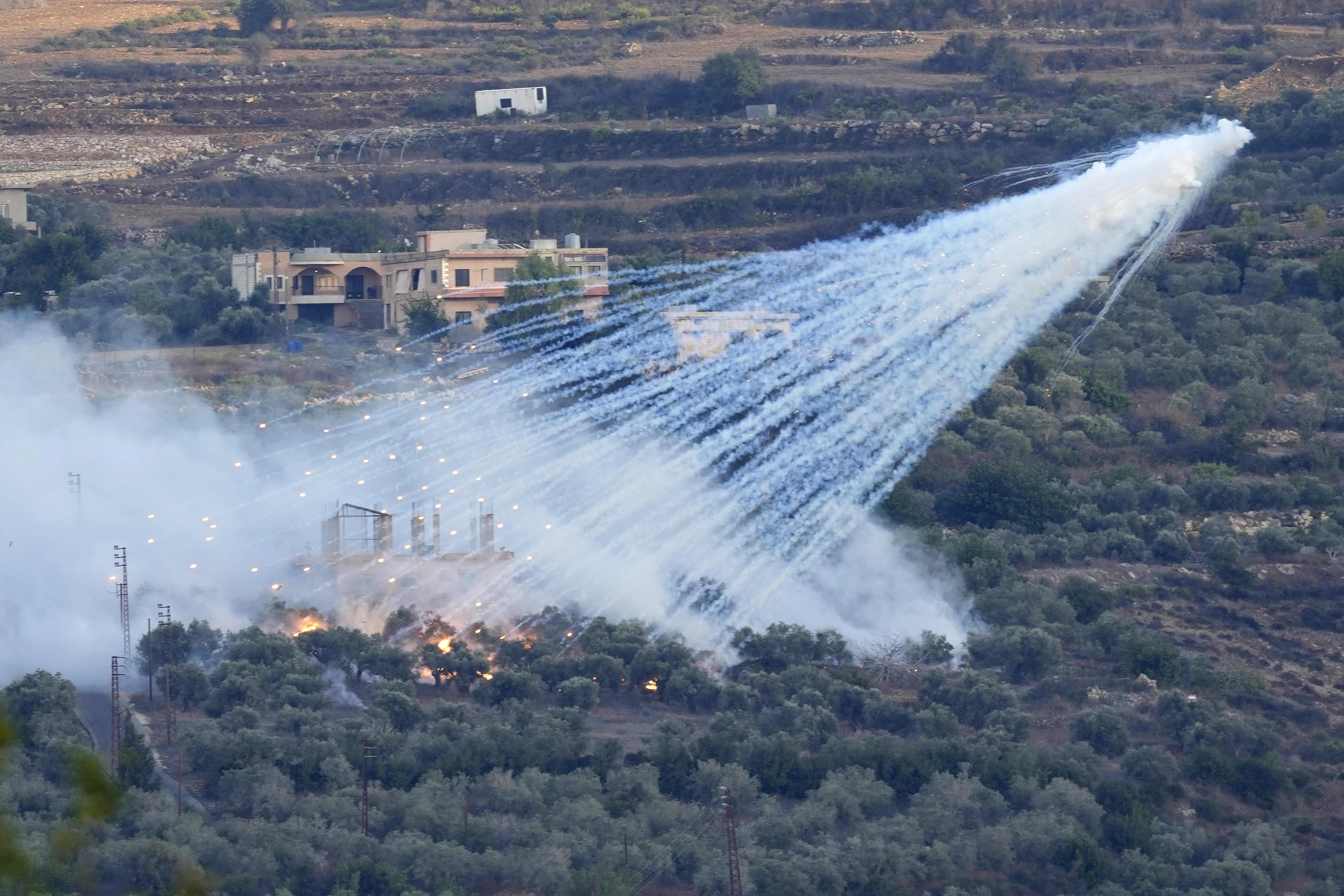 whit phosphorous exploding over green lands