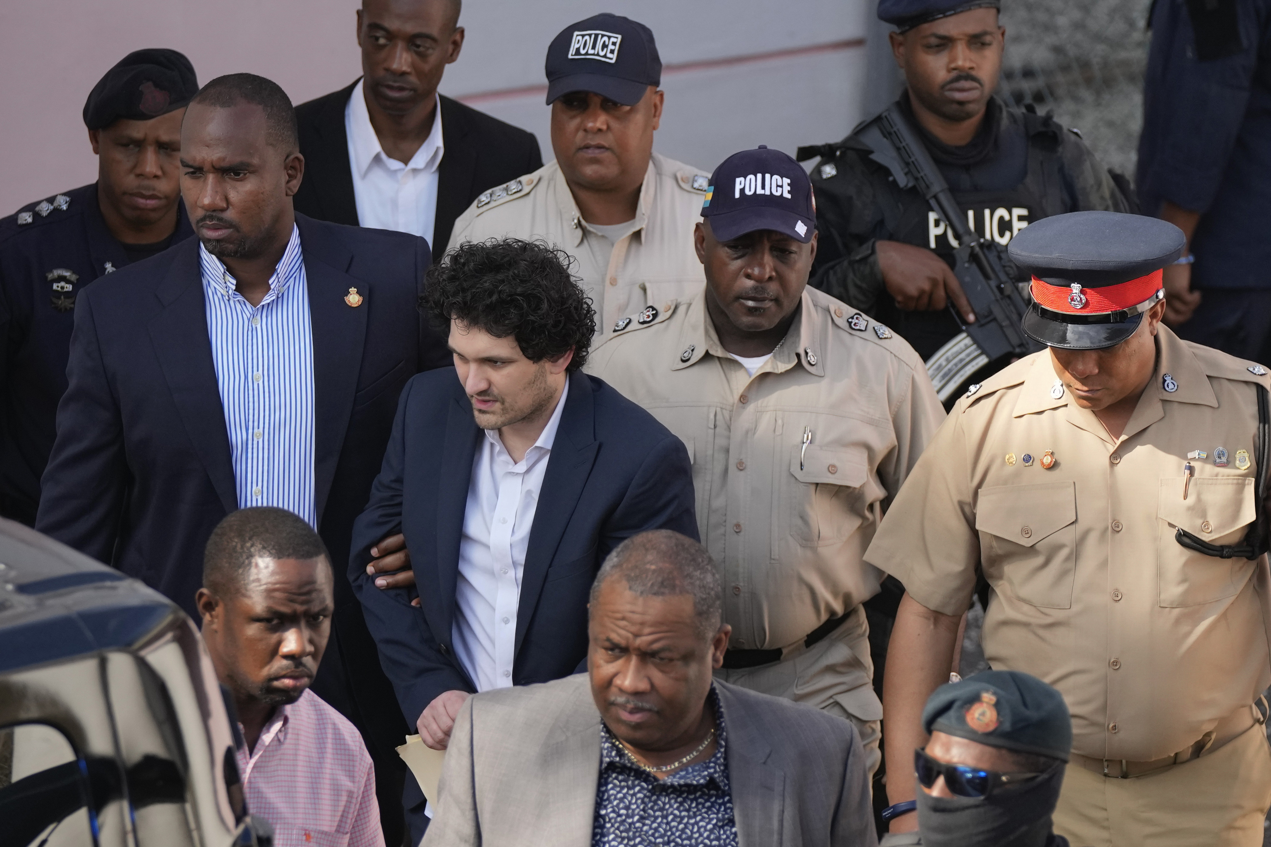 Sam Bankman-Fried, centre left, is escorted out of Magistrate Court following a hearing in Nassau, Bahamas, Dec. 19, 2022