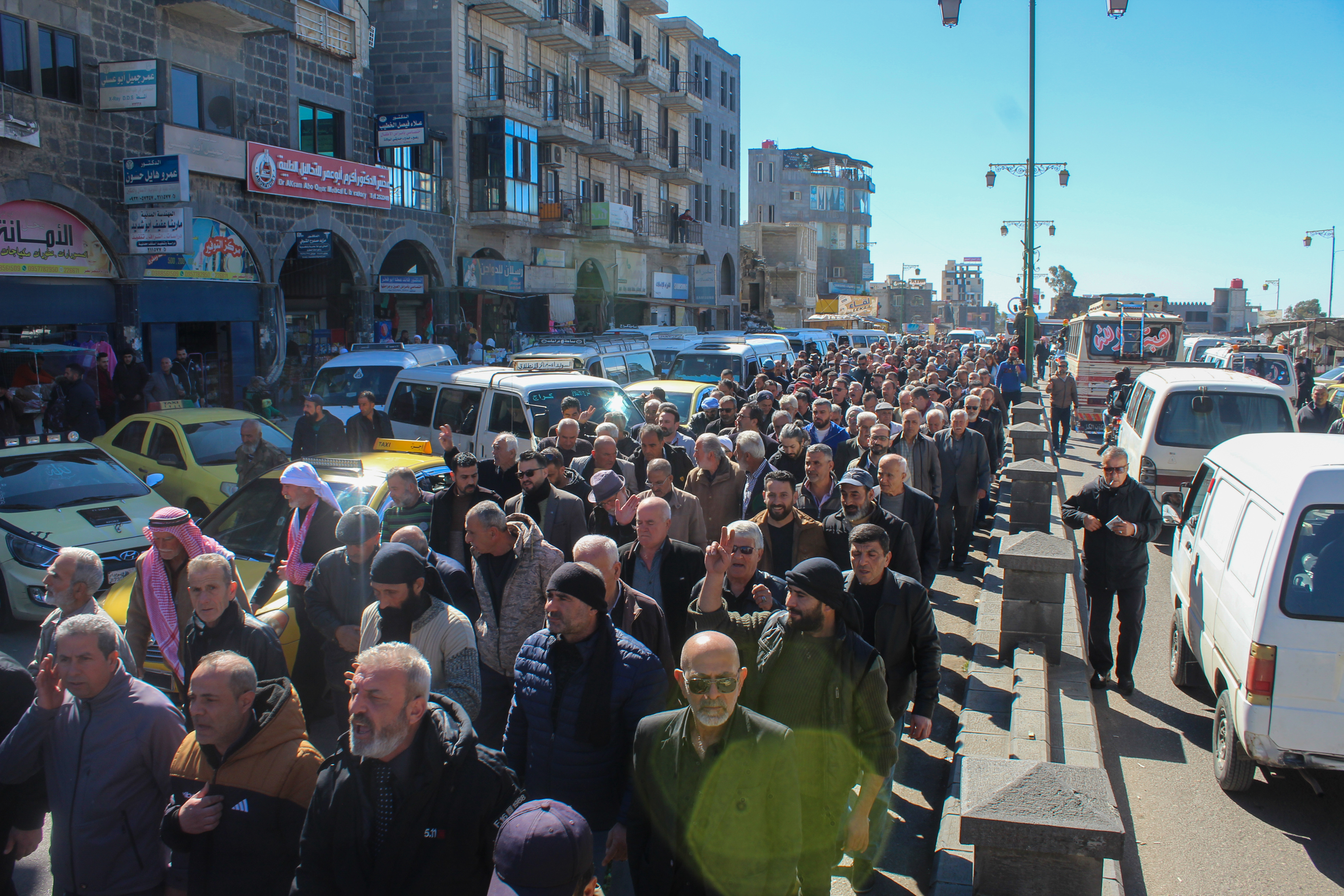 Mourners and protesters march in Sweida on Thursday at the funeral of Jawad al-Barouki, 52, killed by Syrian regime forces during a protest earlier in the week