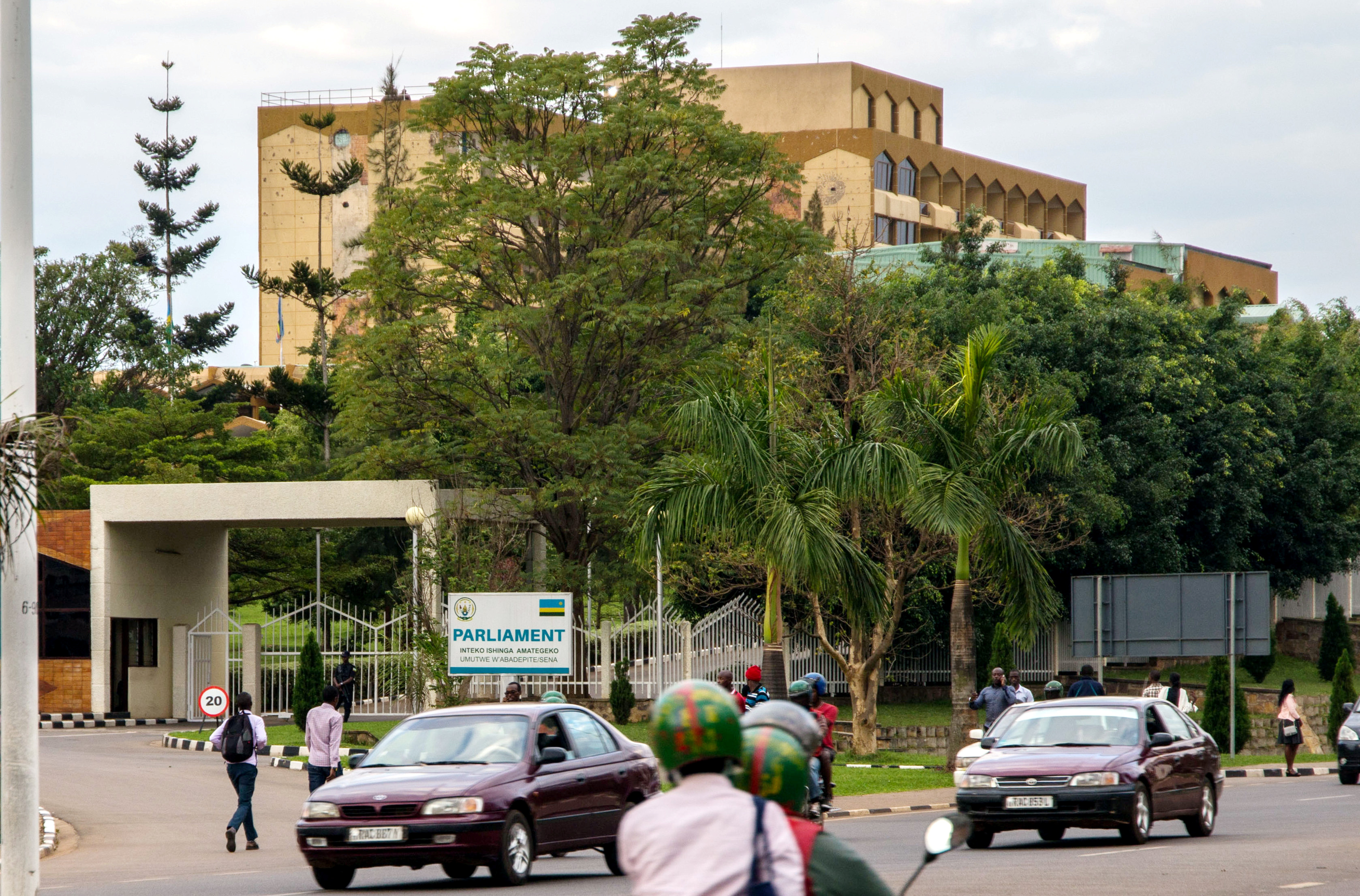 Motorists drive past the Parliament buildings in Kigali, Rwanda