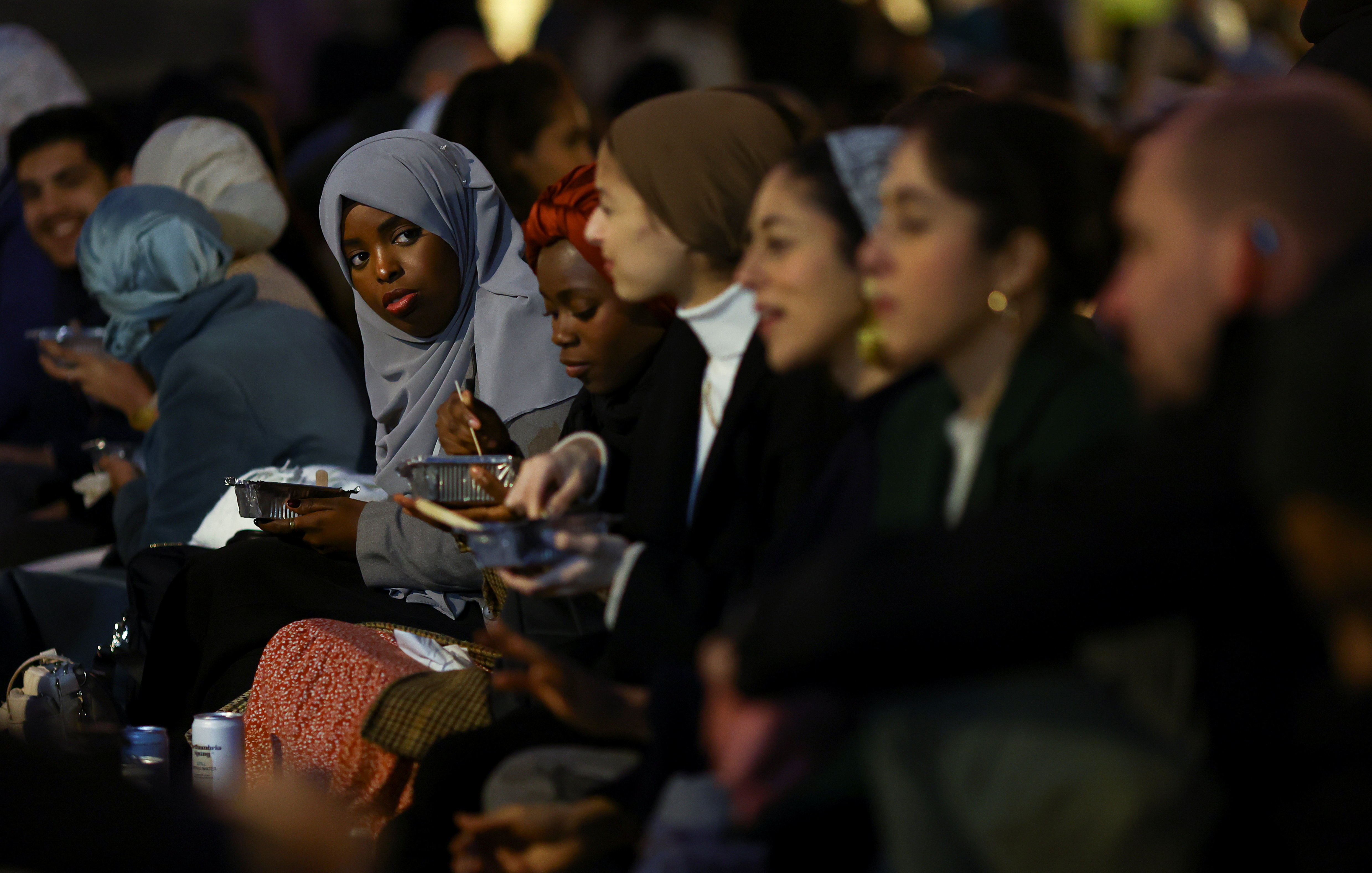 A woman reacts at an open Iftar, during the fasting month of Ramadan, in London, Britain April 13, 2022