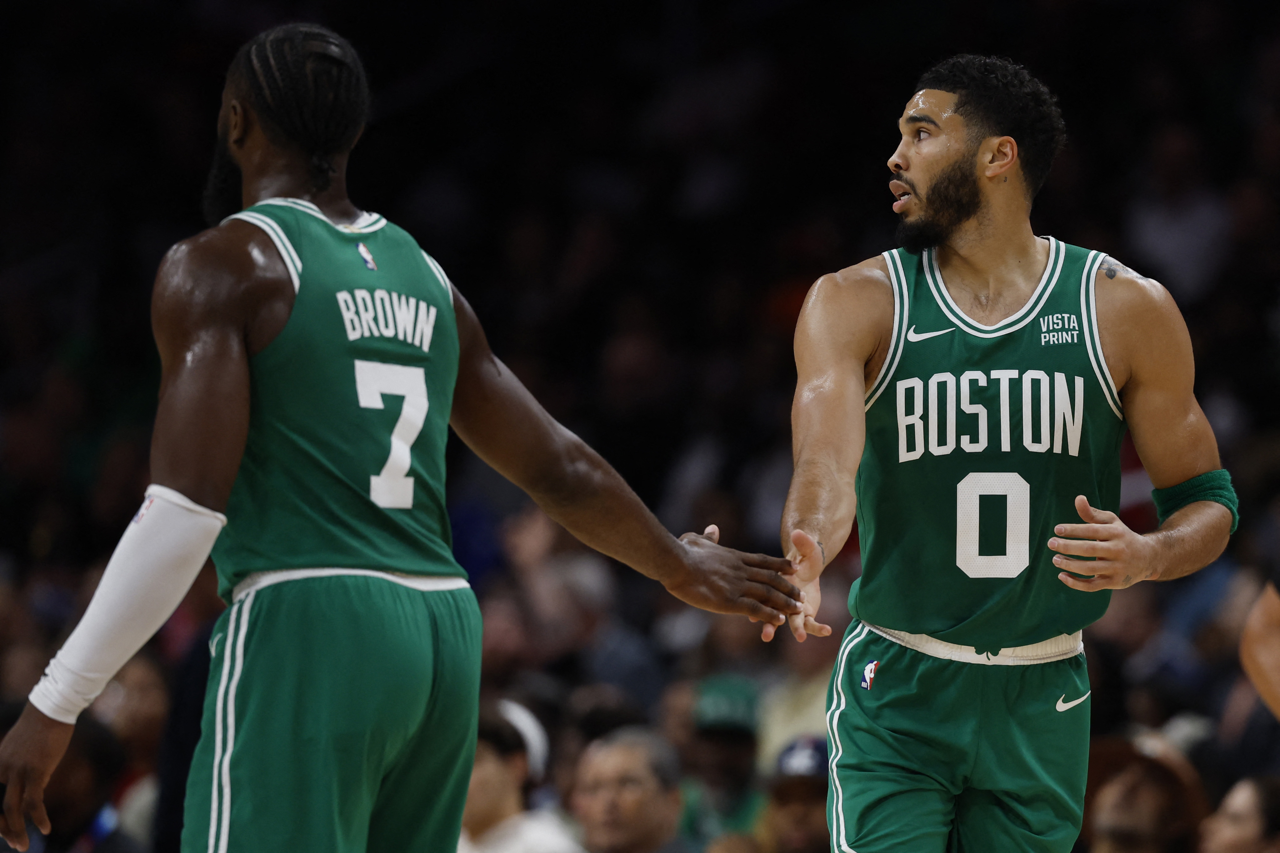 Celtics forward Jayson Tatum, 0, celebrates with Celtics teammate Jaylen Brown, 7