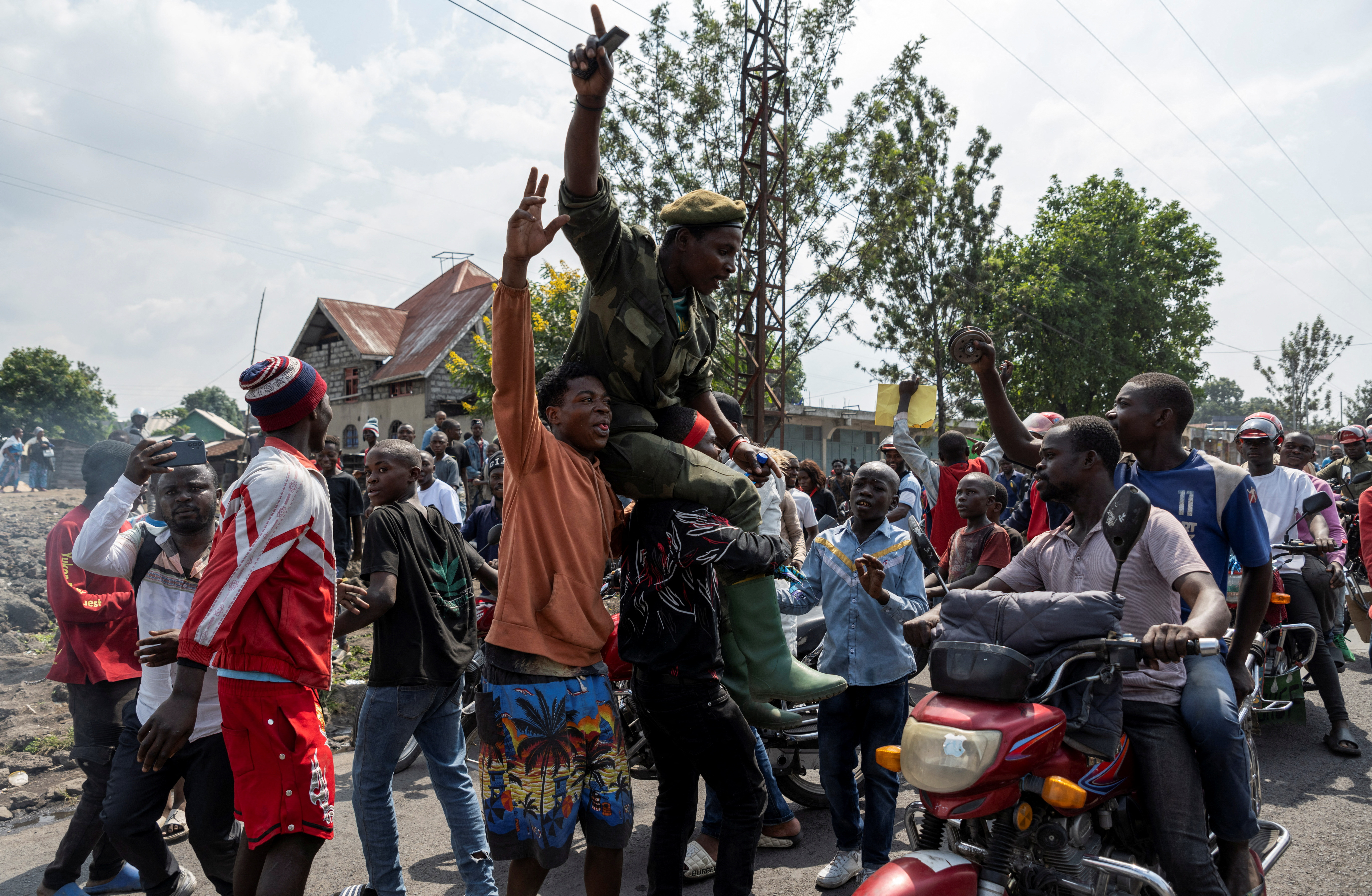 Activists lift a supporter of the Wazalendo during a demonstration calling for an end to the fighting between the M23 rebels and the Congolese army, denouncing the international community’s silence on the conflicts, in Goma, North Kivu province of DR Congo, on February 19, 2024