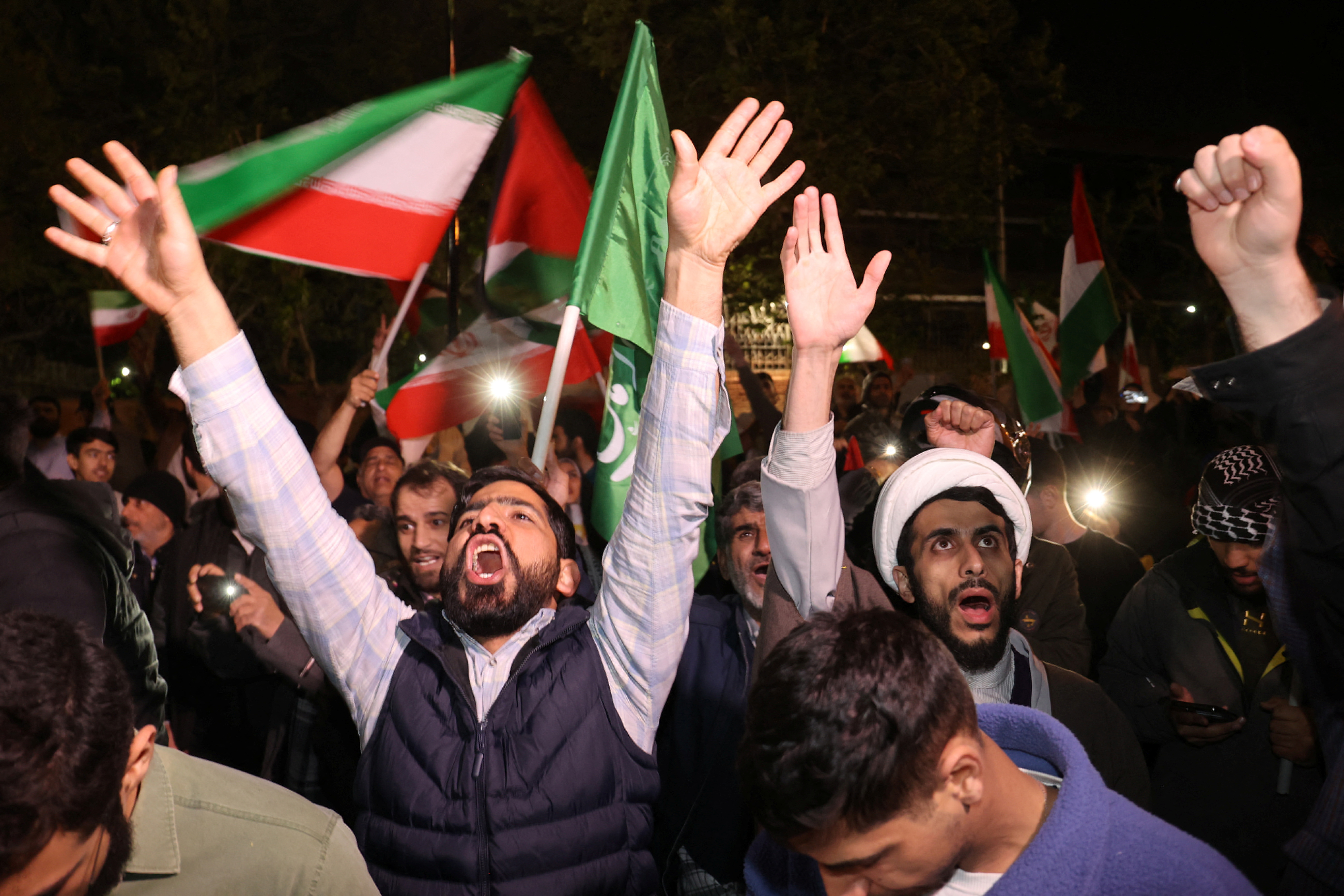 Iranian demonstrators react after the IRGC attack on Israel during an anti-Israeli gathering in front of the British embassy in Tehran