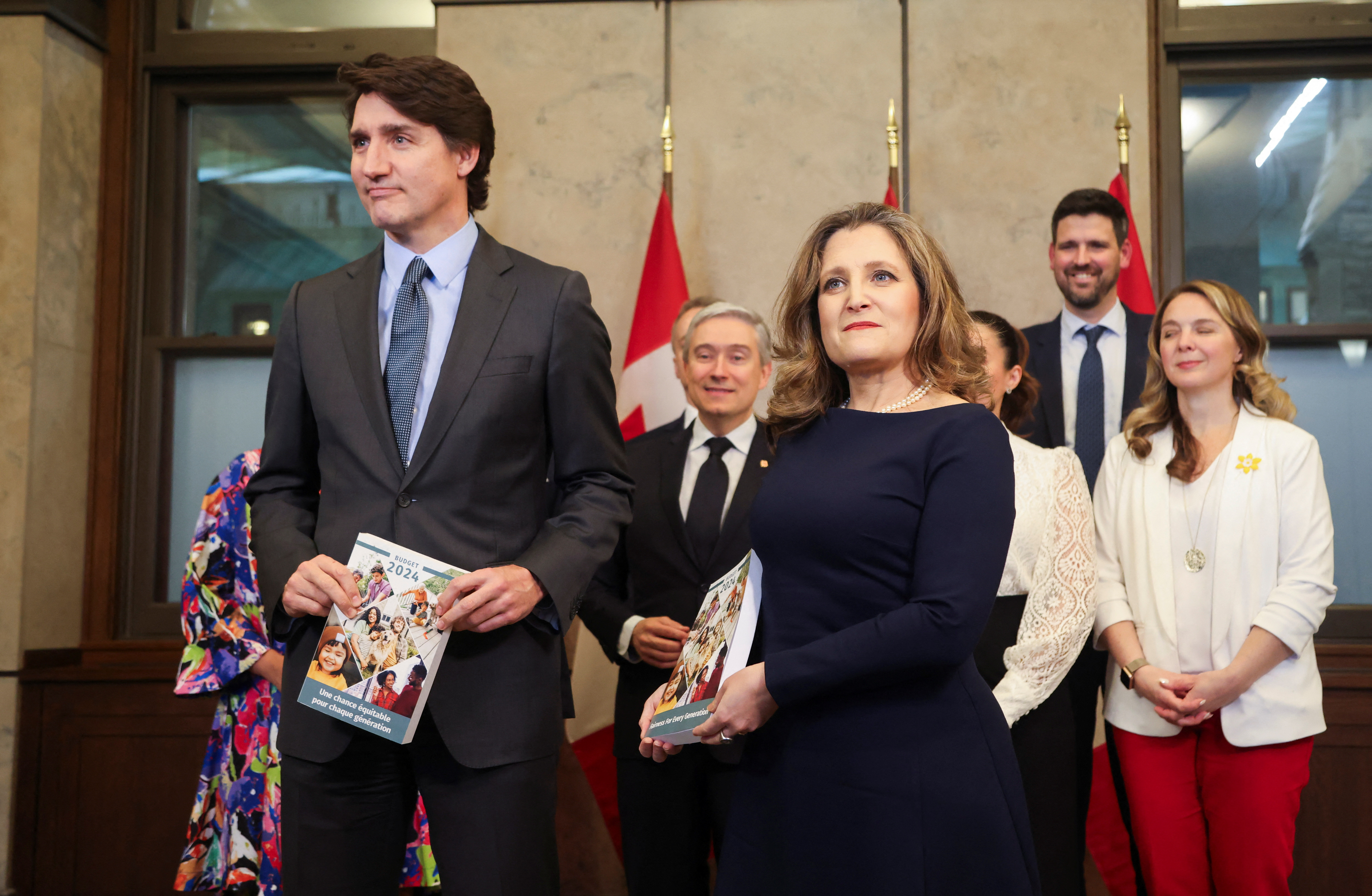 Trudeau and former Finance Minister Chrystia Freeland pose for a photo holding Canada’s 2024-25 budget, in April 2024