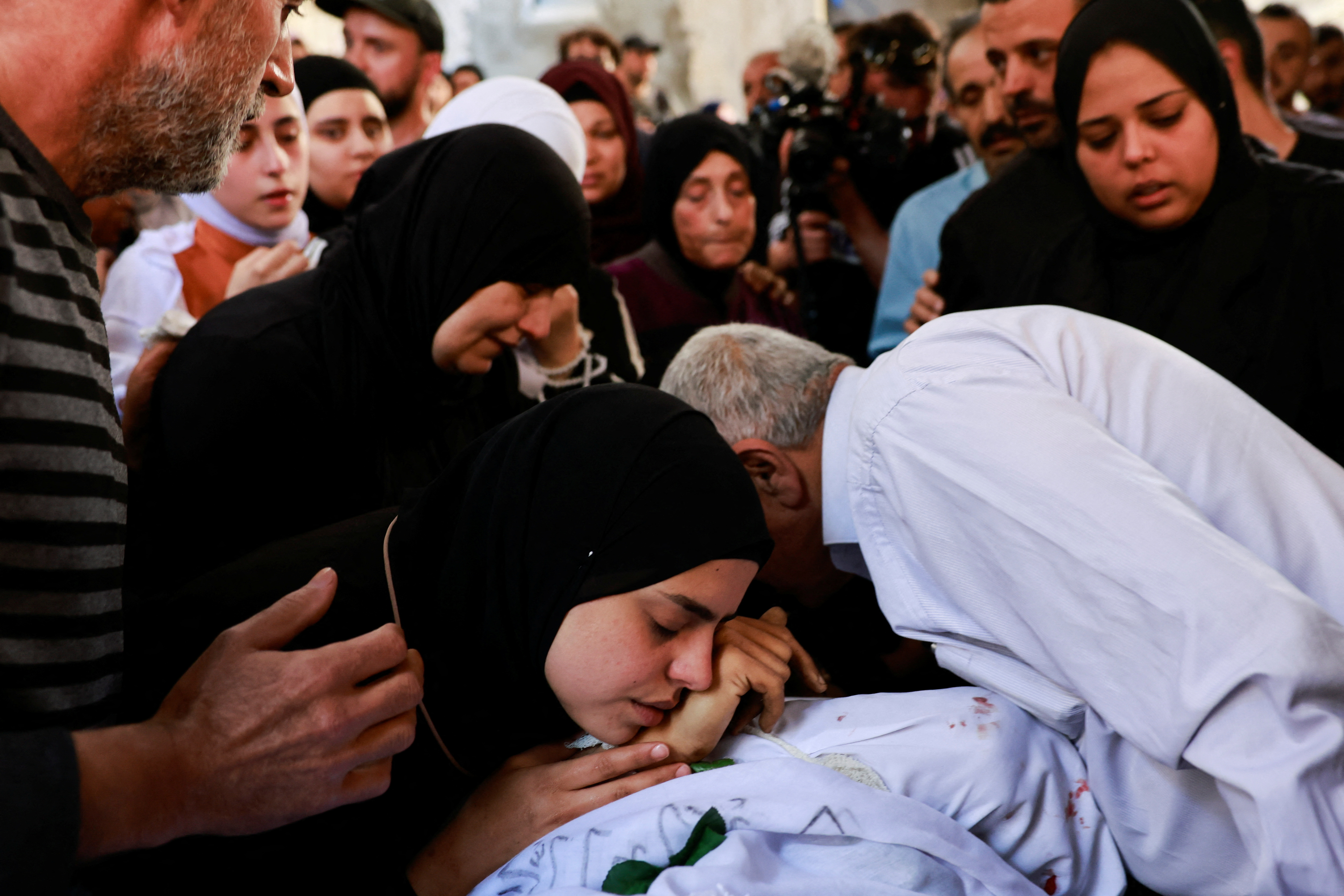 People mourn during the funeral for the Palestinians killed in an Israeli raid, in Nur Shams camp, Tulkarm, in the Israeli-occupied West Bank, April 21