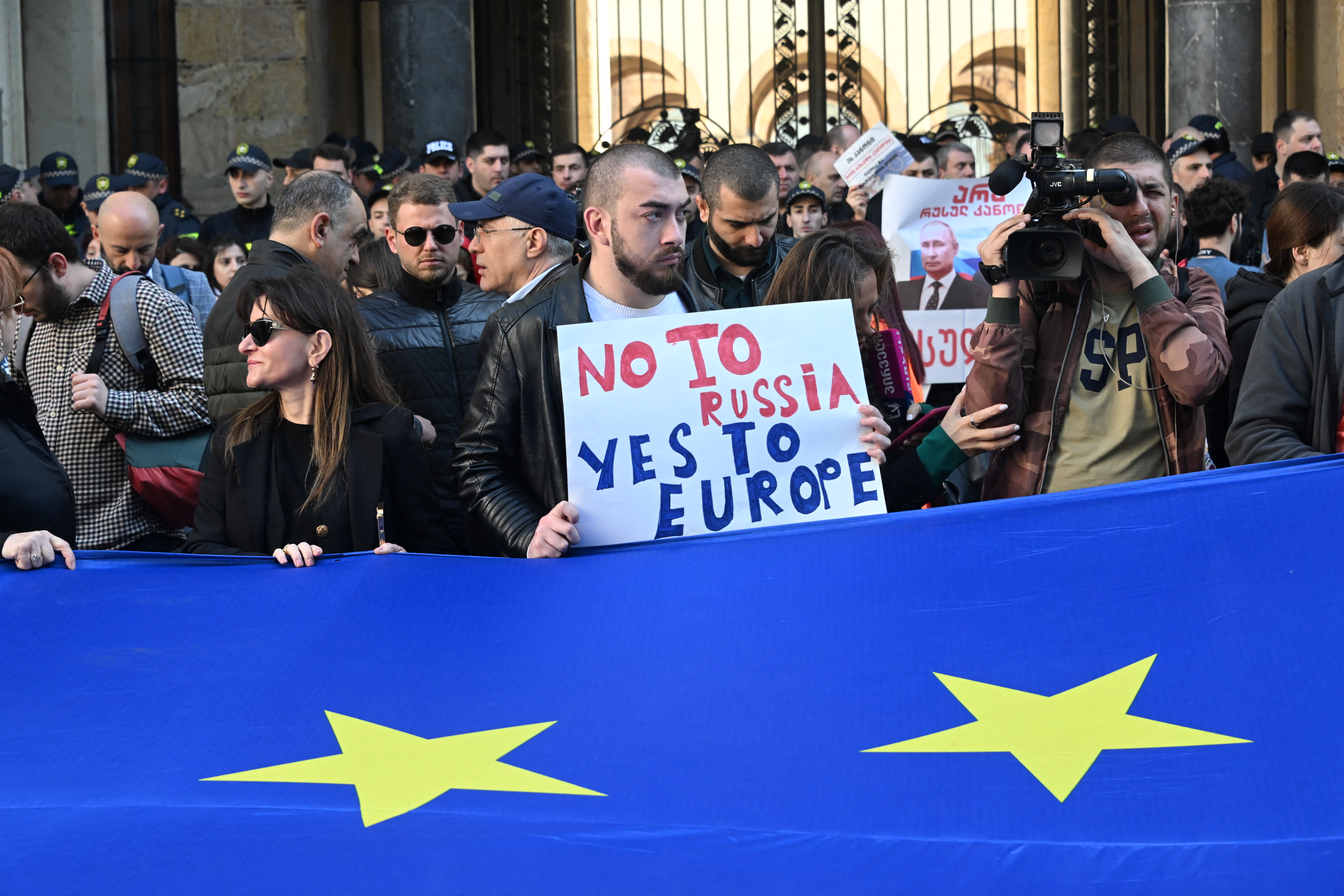 Georgian pro-democracy groups activists protest against a repressive "foreign influence" bill outside the parliament in Tbilisi on April 15, 2024. The revived controversial proposal, denounced by the European Union which Tbilisi aspires to join, that sparked mass demonstrations last year, would target NGOs, media organisations and individual journalists who receive foreign funding. It mirrors Russia's "foreign agent" law that has been used by the Kremlin to silence dissidents. (Photo by Vano SHLAMOV / AFP)