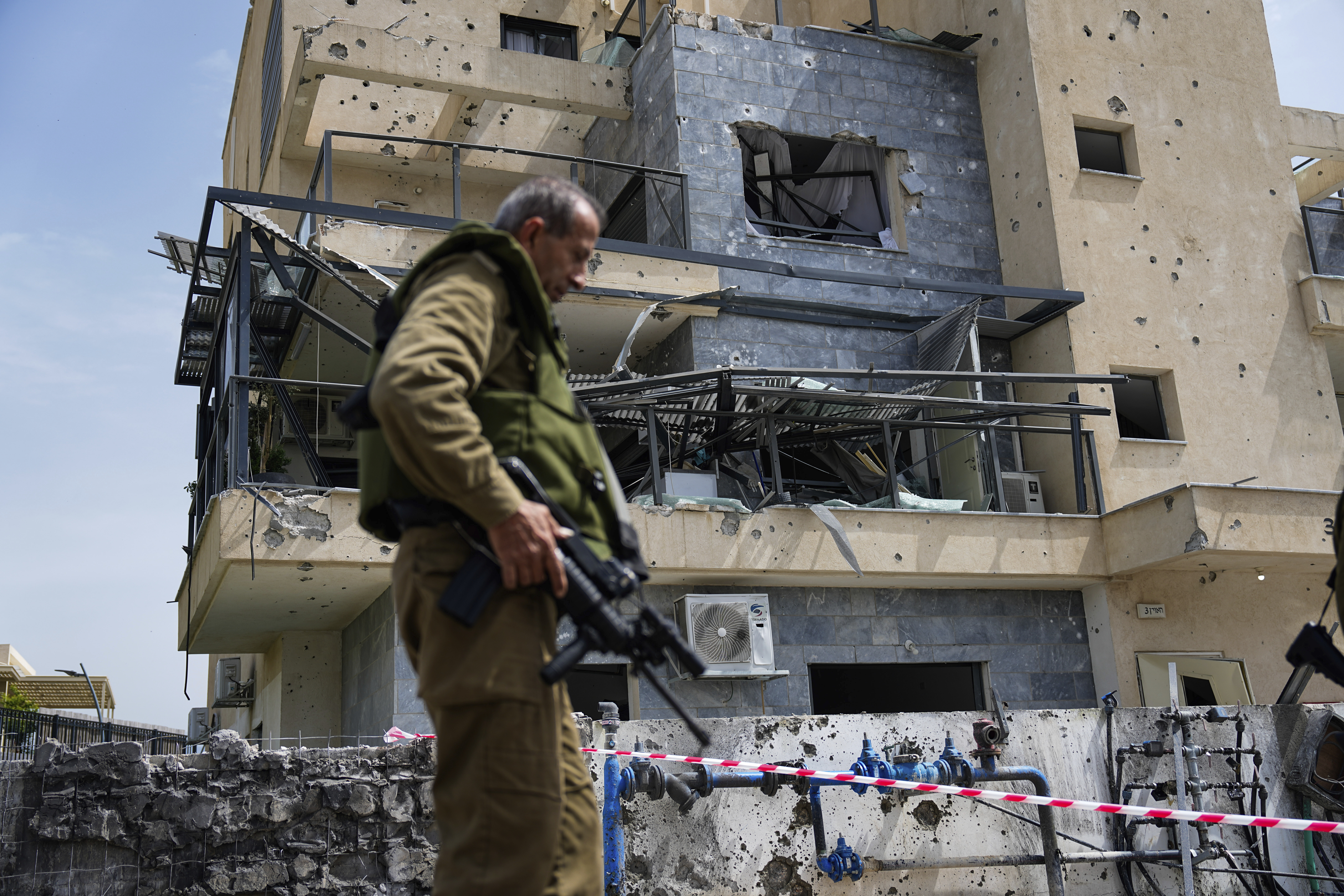 Israeli security forces examine a site hit by a rocket fired from Lebanon in Kiryat Shmona in northern Israel on March 27, 2024