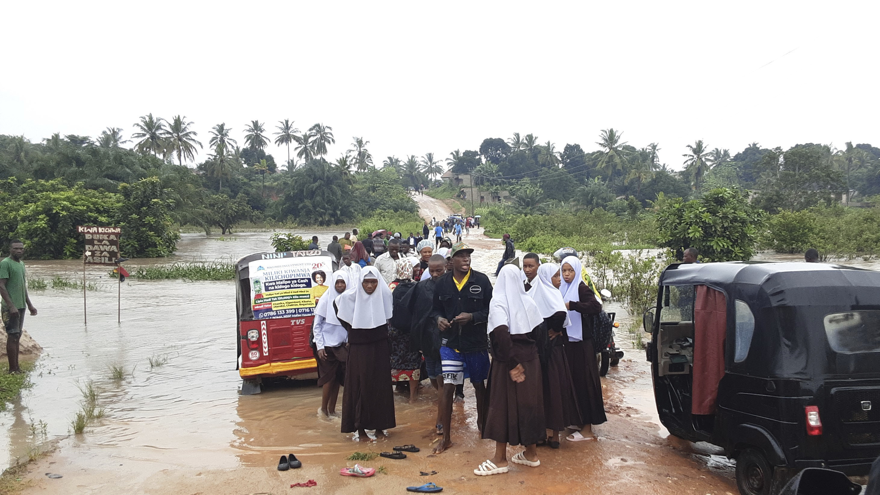 Schoolchildren are stranded due to a damaged River Zingiziwa bridge in Dar es Salaam, Tanzania [AP]