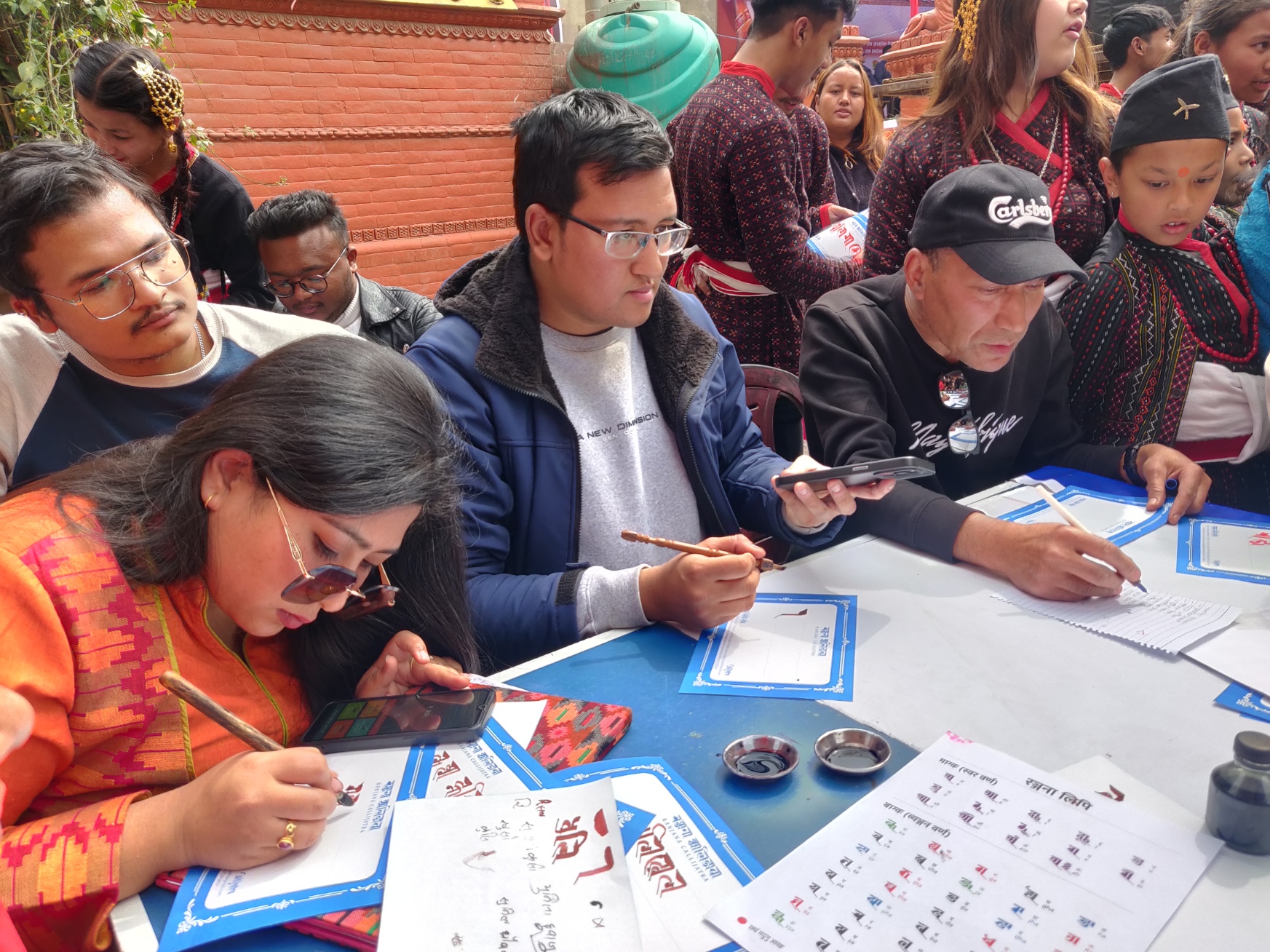 Lalima Shrestha (left) and Suyogya Ratna Tamrakar (beside Lalima) at the live calligraphy session in Dhulikhel