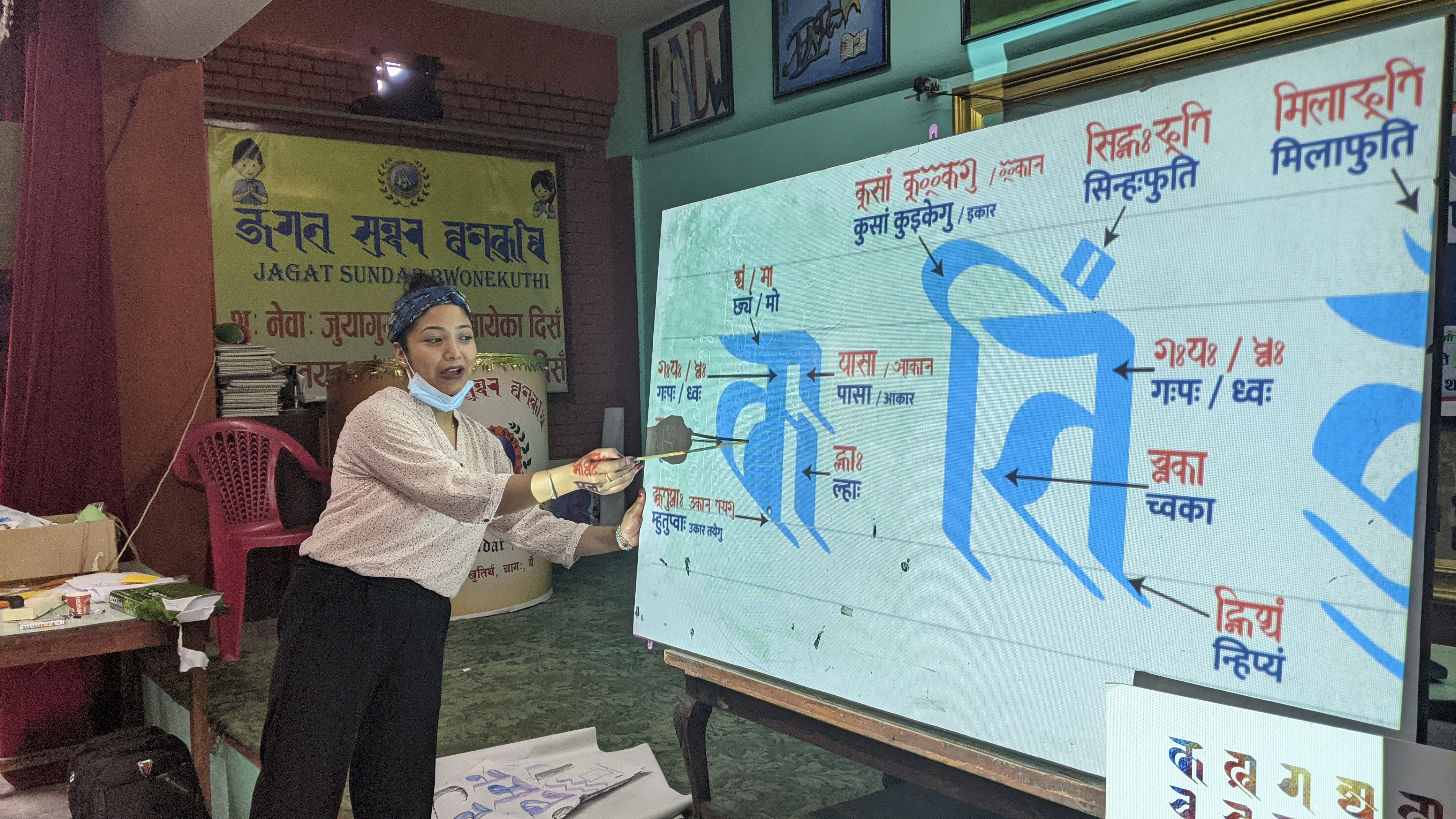 Sunita Dangol, a member of Callijatra, explains the Ranjana alphabet at a workshop [Courtesy of Callijatra]