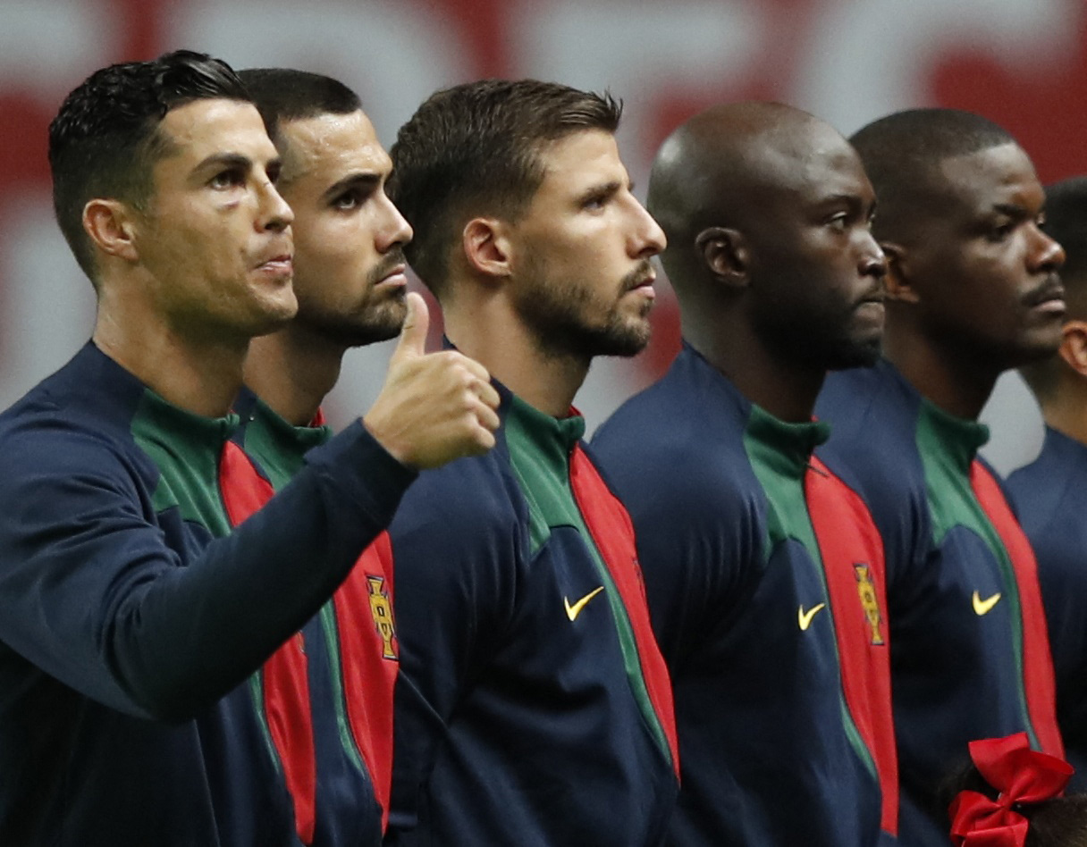 Football players standing in a row before kickoff.