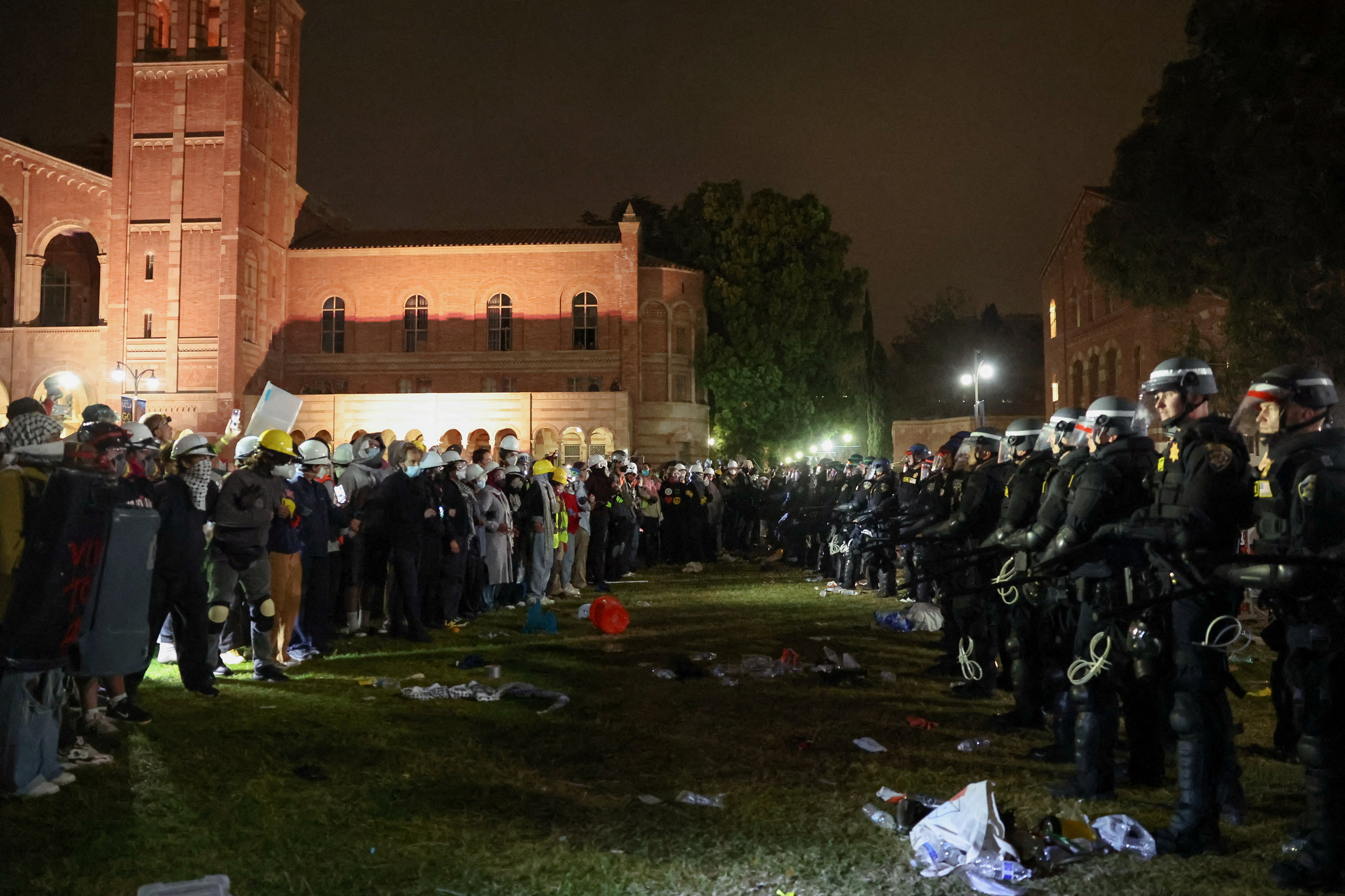 Law enforcement officers stand in front of demonstrators during a protest at an encampment in support of Palestinians at the University of California Los Angeles (UCLA), as the conflict between Israel and the Palestinian Islamist group Hamas continues, in Los Angeles, California, US, May 2, 2024