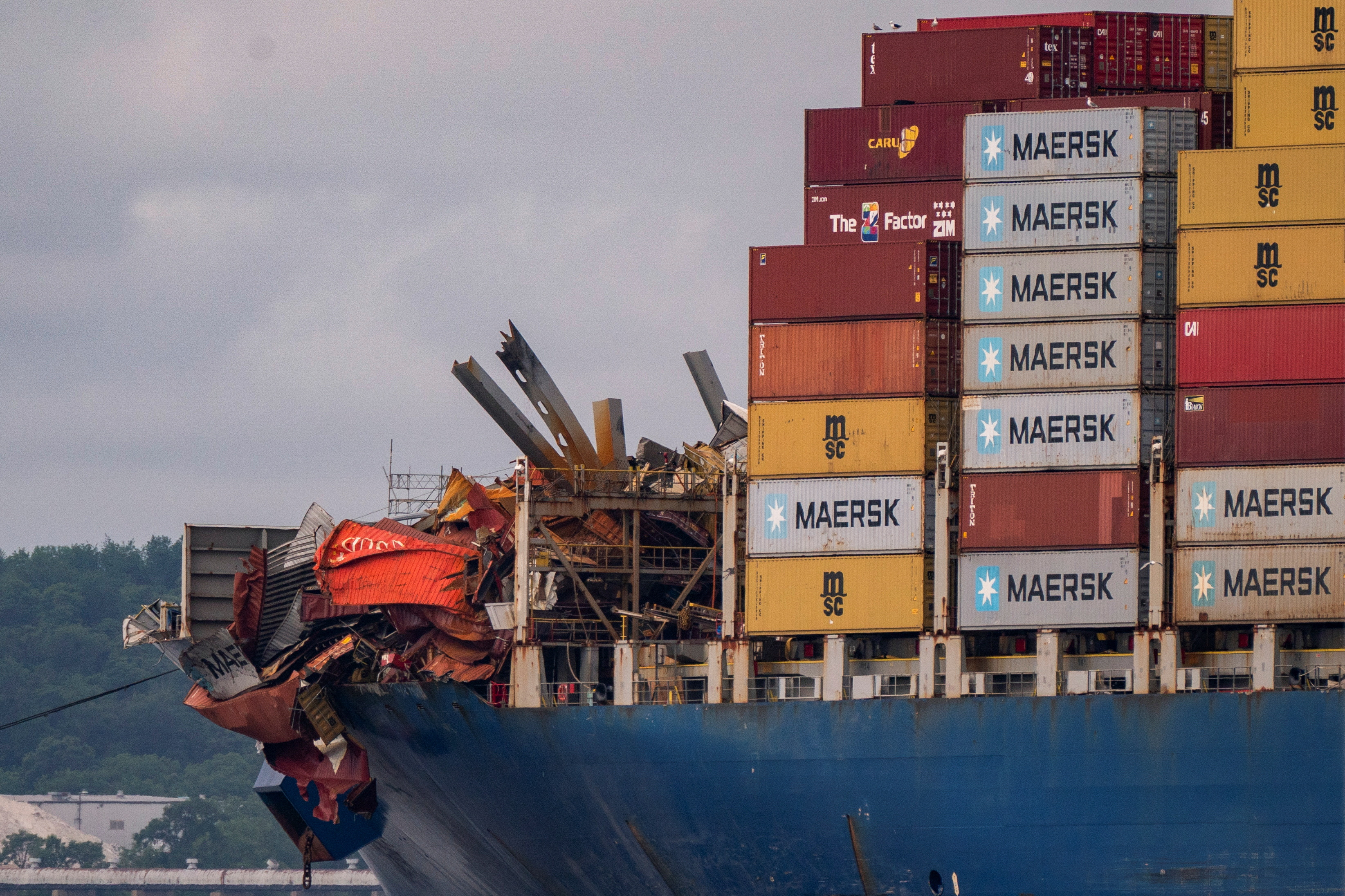 The cargo ship Dali is towed to port from the Baltimore bridge it crashed into in March