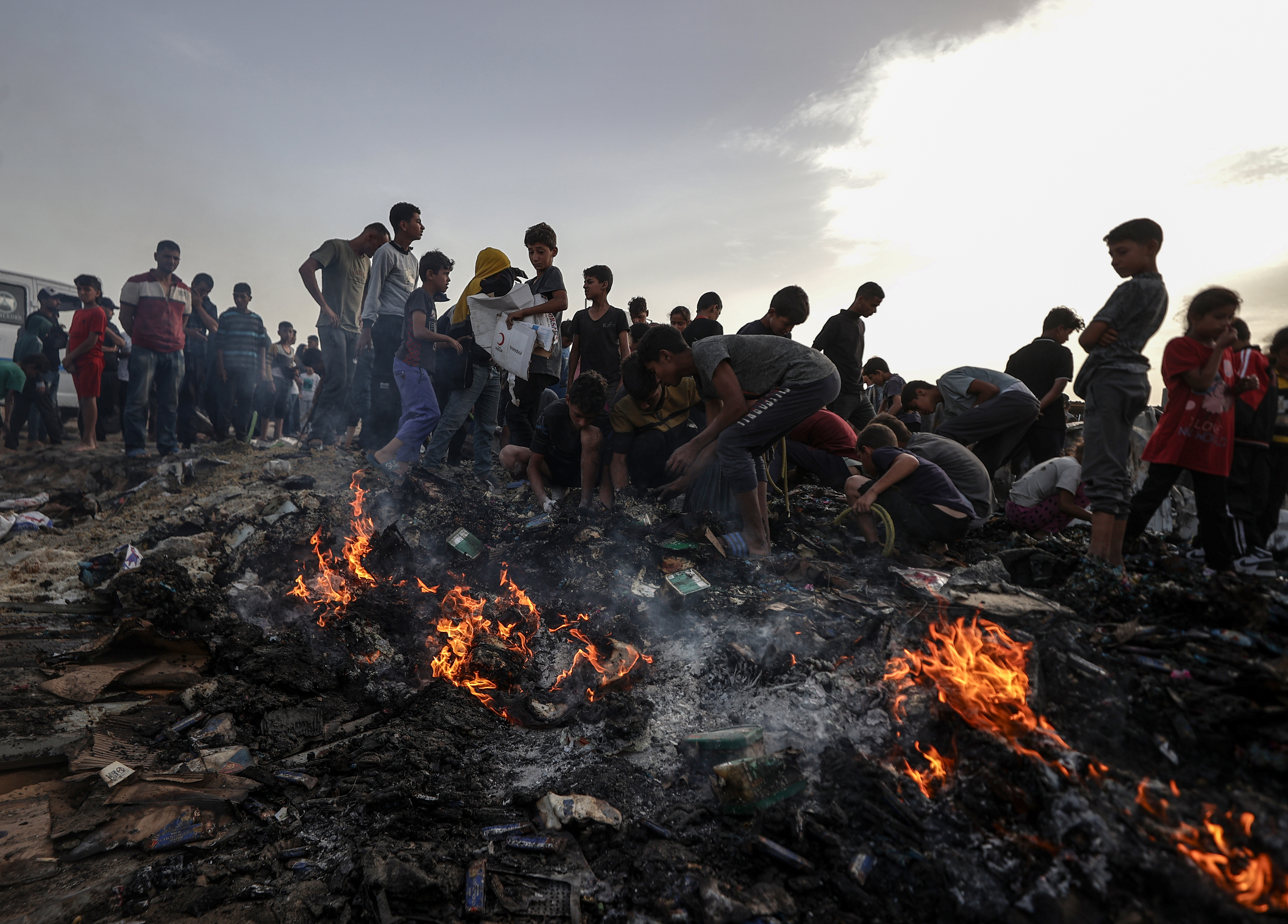Palestinians observe the destruction caused by the Israeli attacks in Rafah