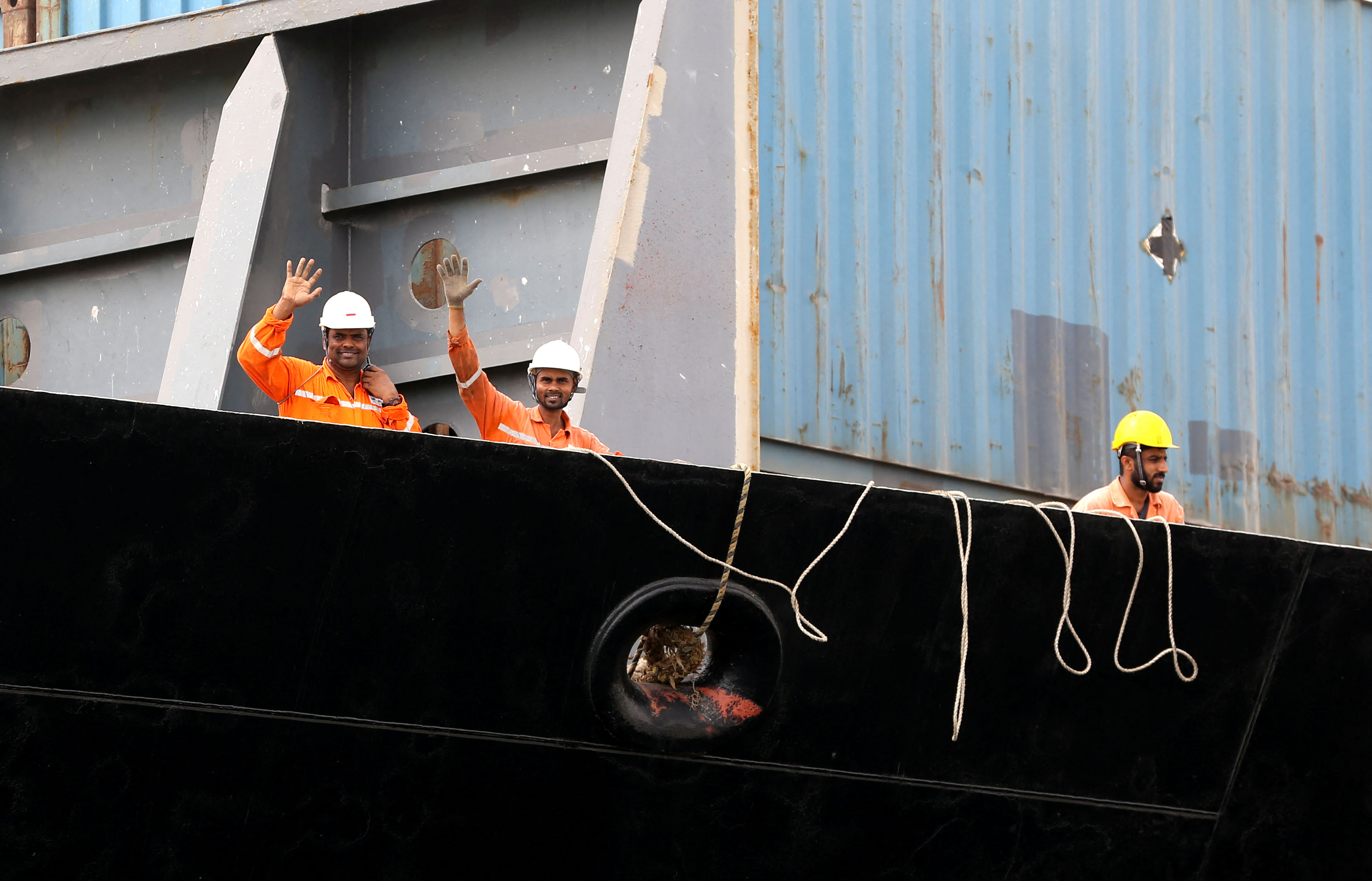 Workers wave at Chabahar Port
