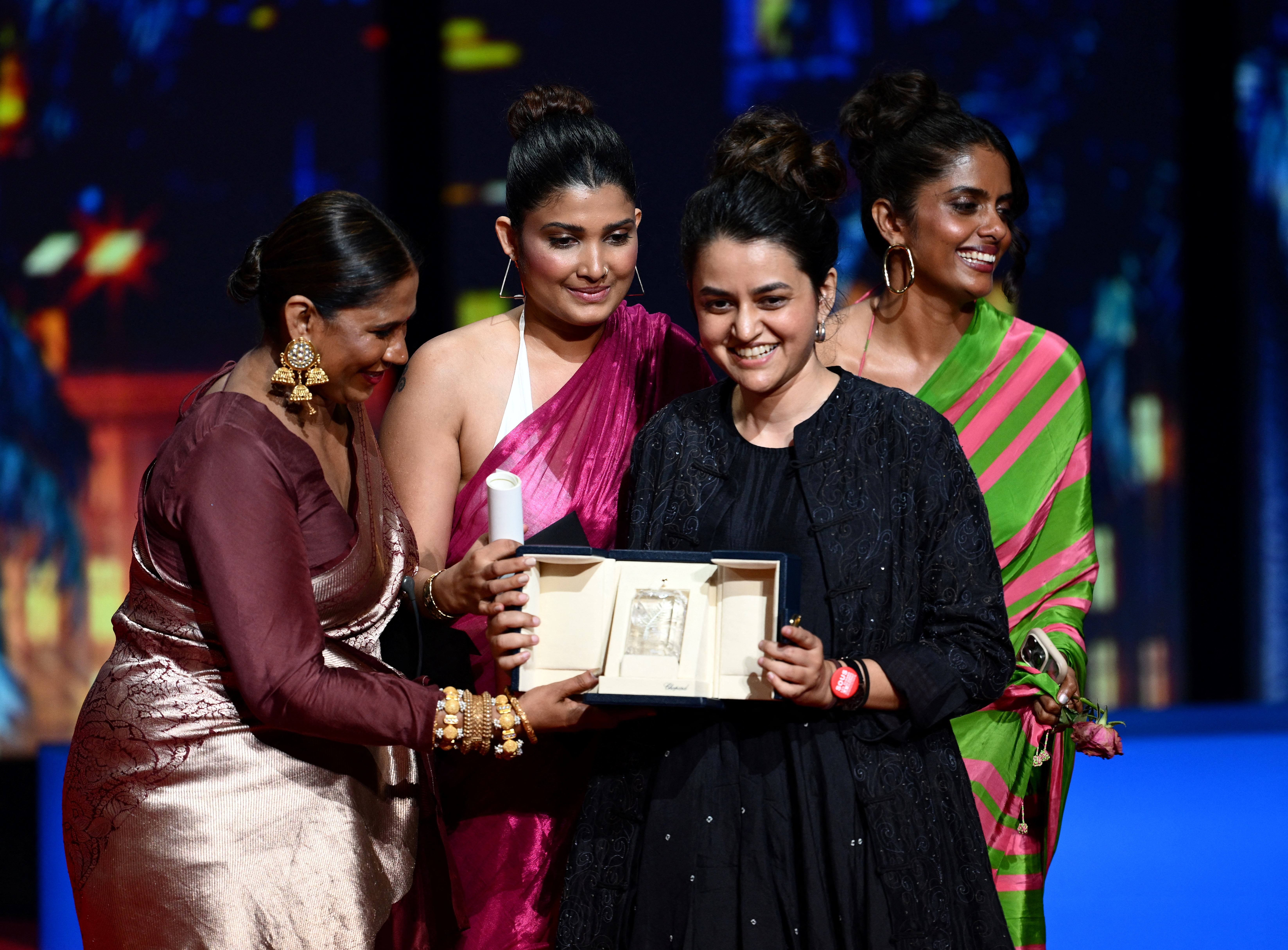 Indian director Payal Kapadia, centre, celebrates on stage with her cast Indian actress Chhaya Kadam, left, Indian actress Divya Prabha, second left, and Indian actress Kani Kusruti, right, after she was awarded the Grand Prix for the film, All We Imagine as Light, during the Closing Ceremony at the 77th edition of the Cannes Film Festival in Cannes