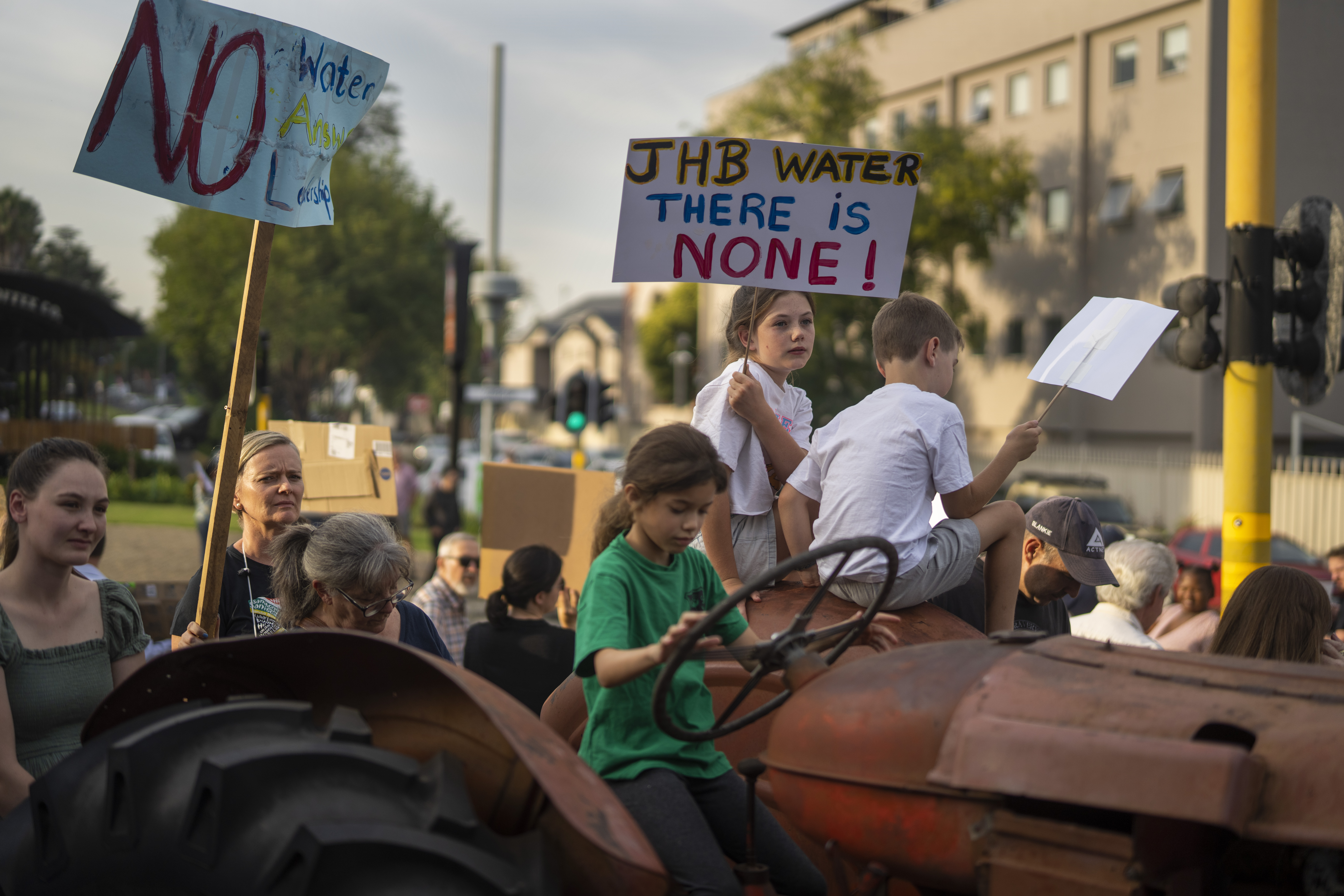 Residents hold signs as they protest against the lack of service delivery in a neighbourhood in Johannesburg [Jerome DelayAP]
