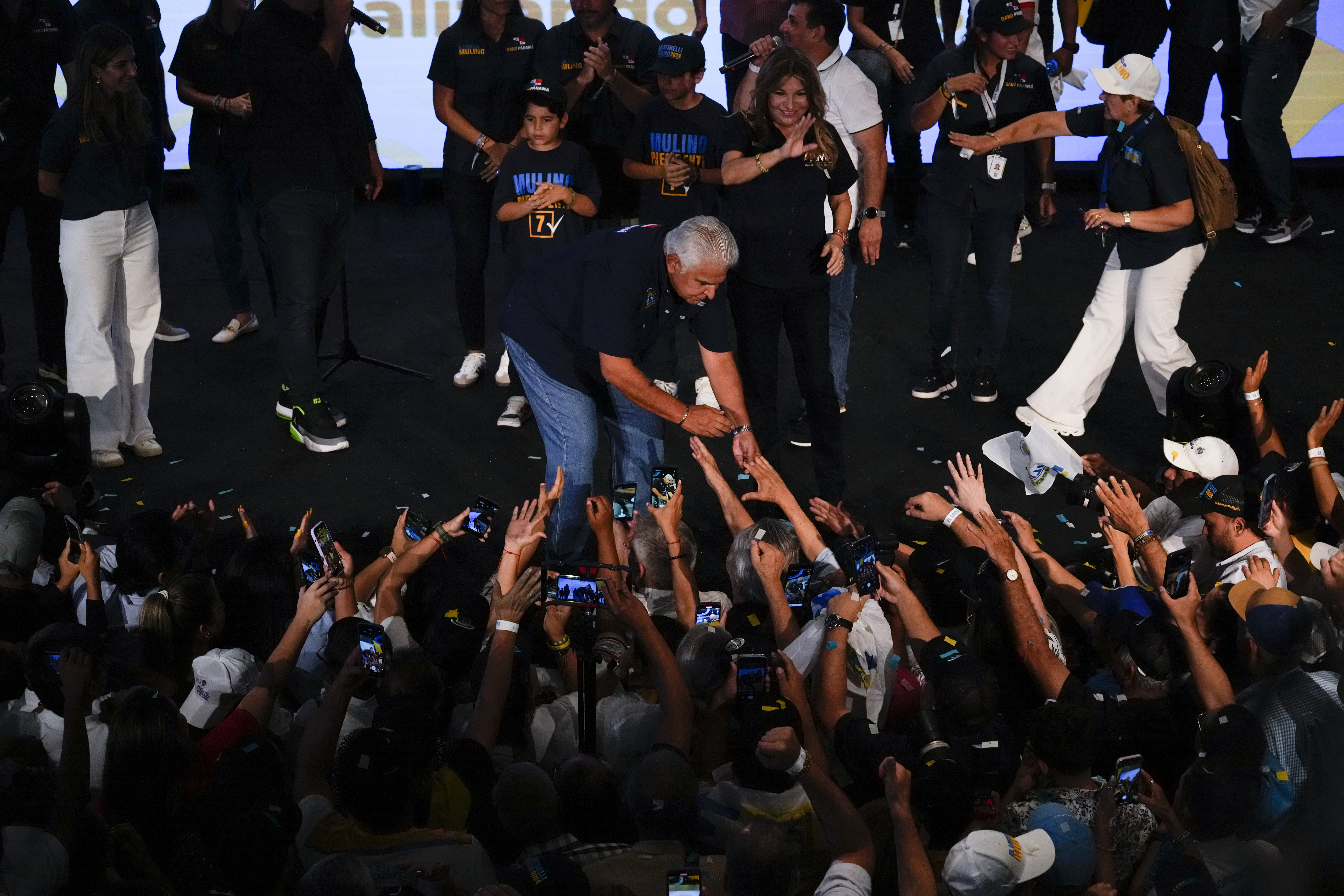 Jose Raul Mulino holds hands with a supporter in Panama City, May 5, 2024