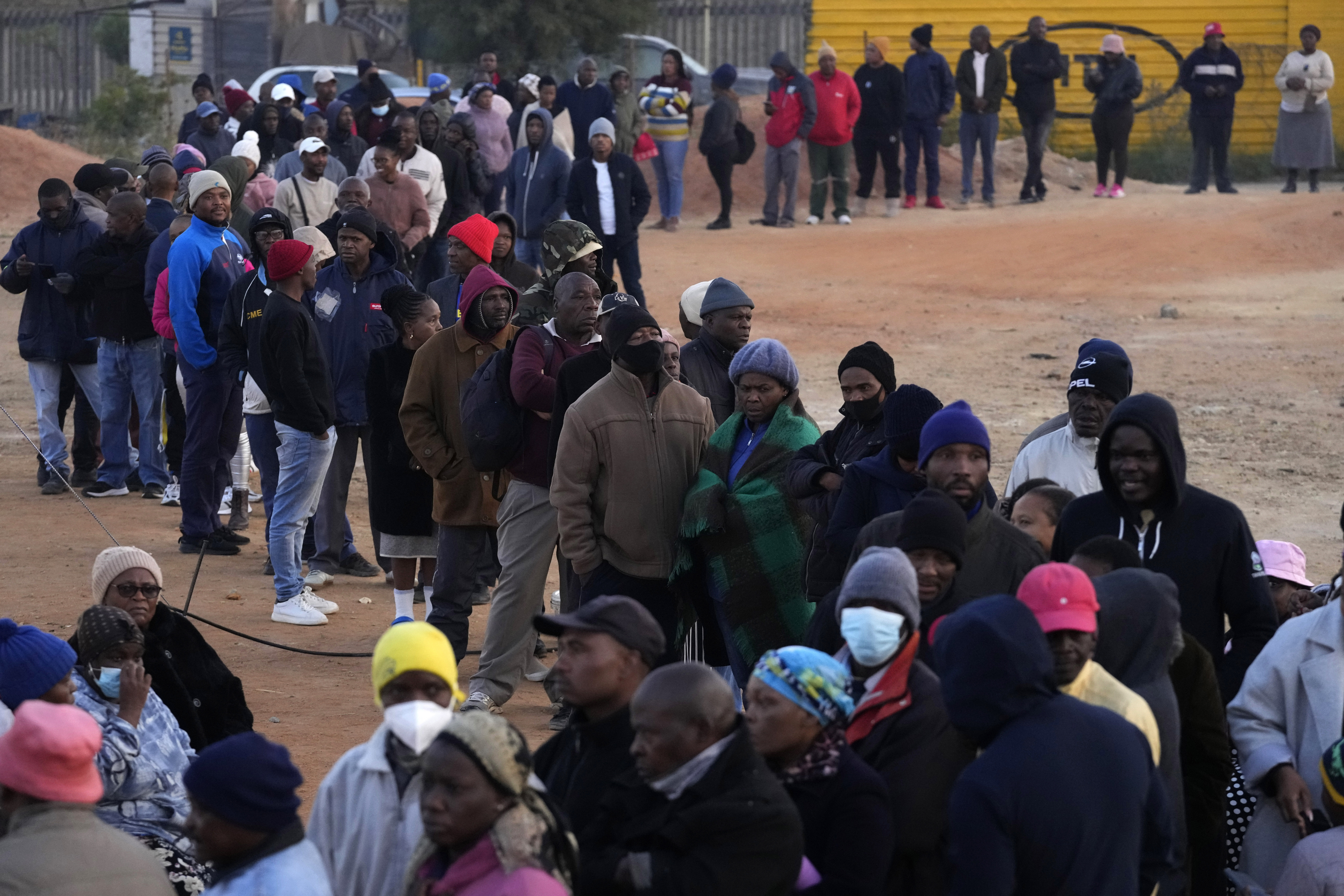 Voters line up to cast their ballot for general elections in Alexandra, near Johannesburg