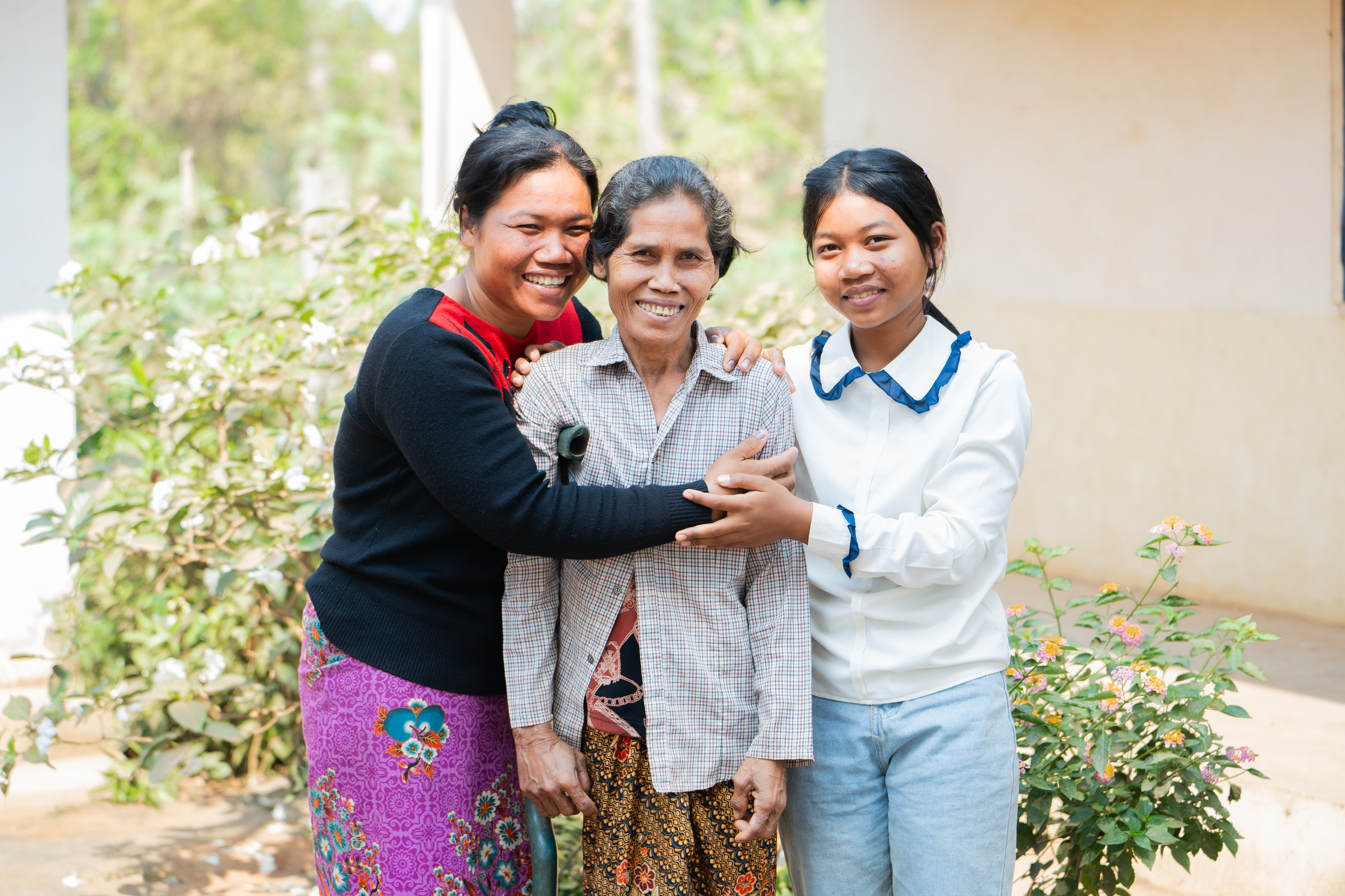 Seila, 13, (pictured right) with her mother Sokna, 35, (left) and her grandmother, Bui Non, 57 (middle) in Siem Reap Province, Cambodia.