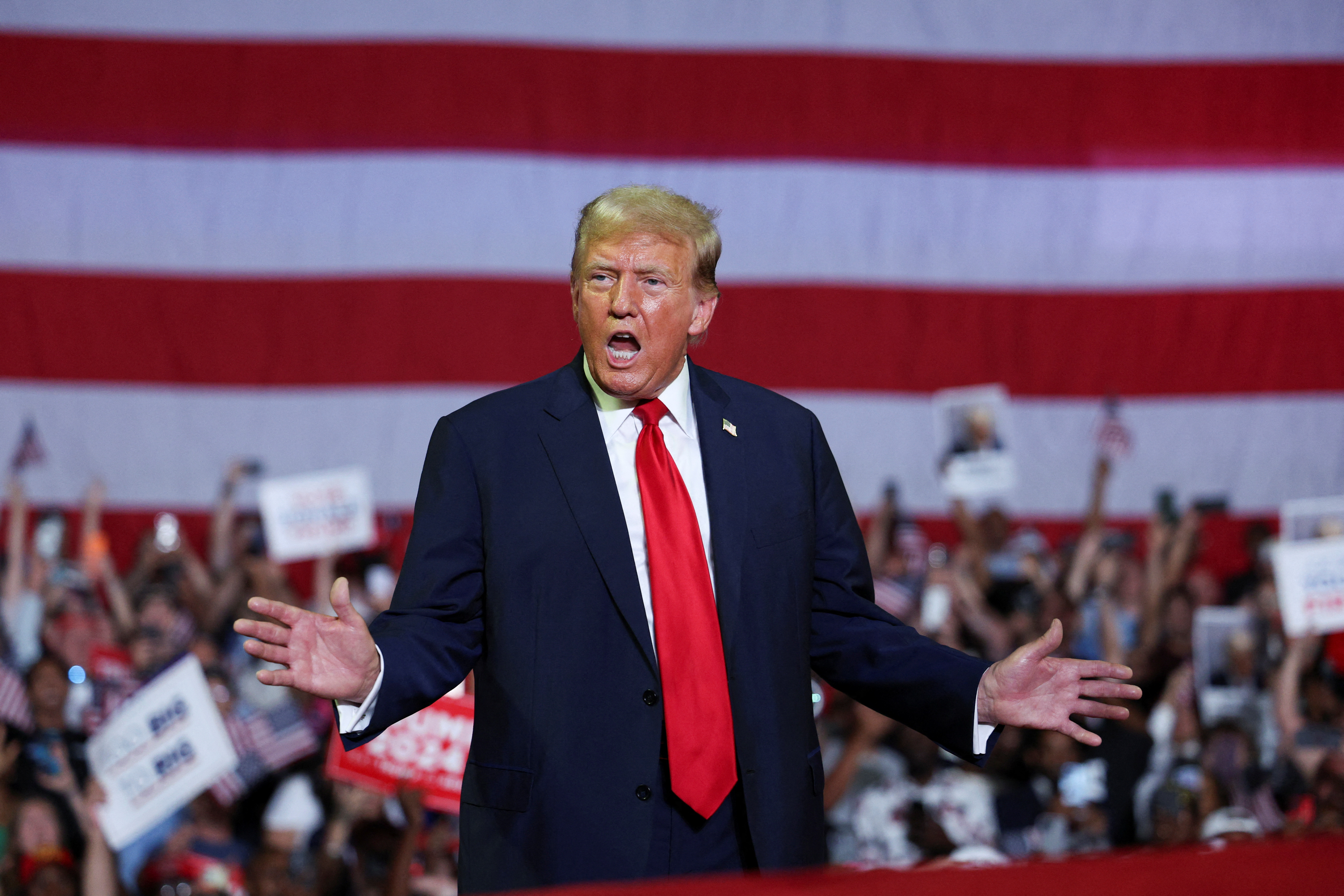 Trump gestures and opens his mouth on stage during a Philadelphia campaign rally