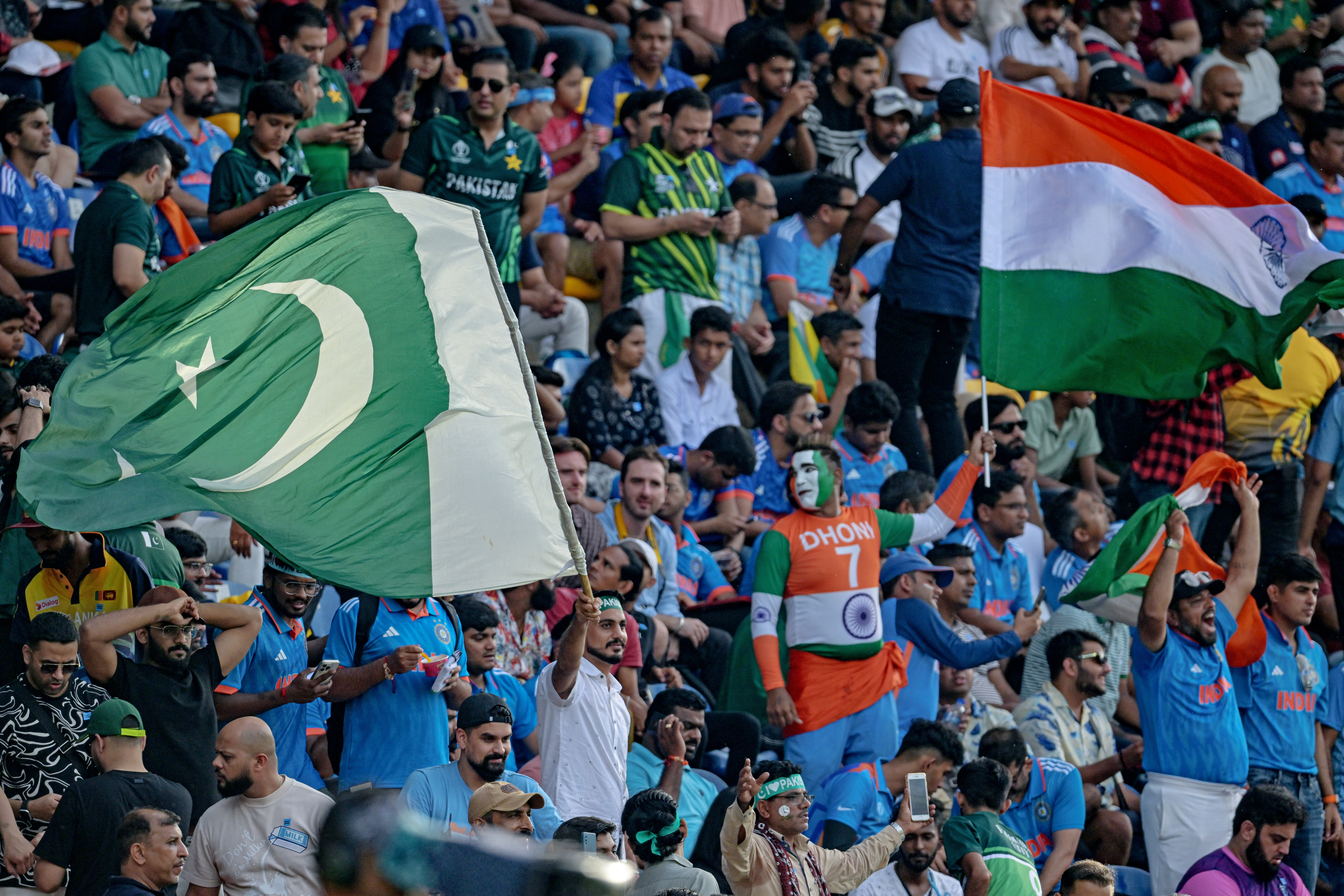 Fans wave the national flags of India and Pakistan during the Asia Cup 2023 ODI cricket match at the Pallekele International Cricket Stadium in Kandy on September 2, 2023