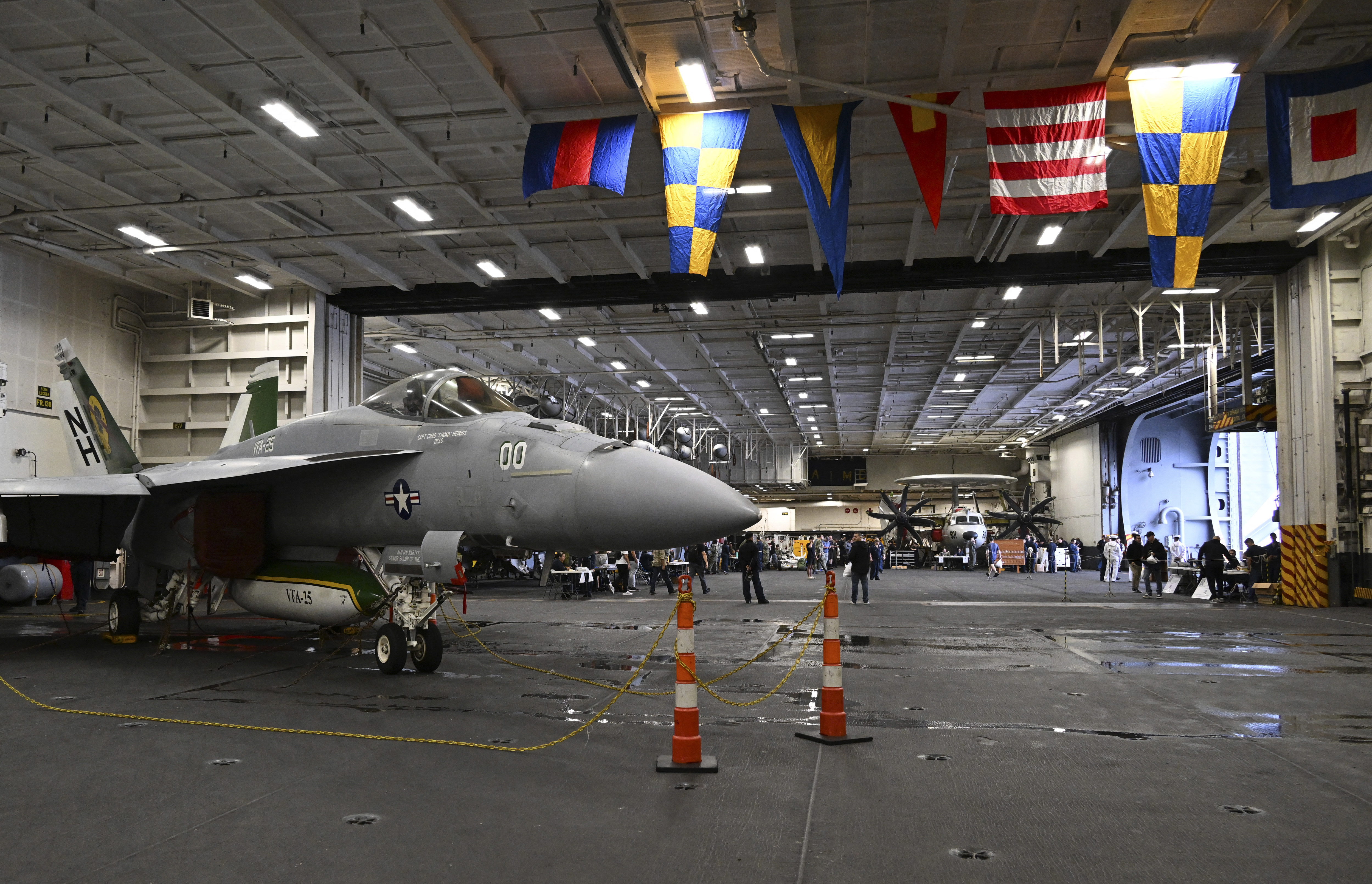 An F-18 fighter aircraft sits in the hanger of the USS Theodore Roosevelt (CVN 71), a nuclear-powered aircraft carrier, anchored in Busan Naval Base in Busan