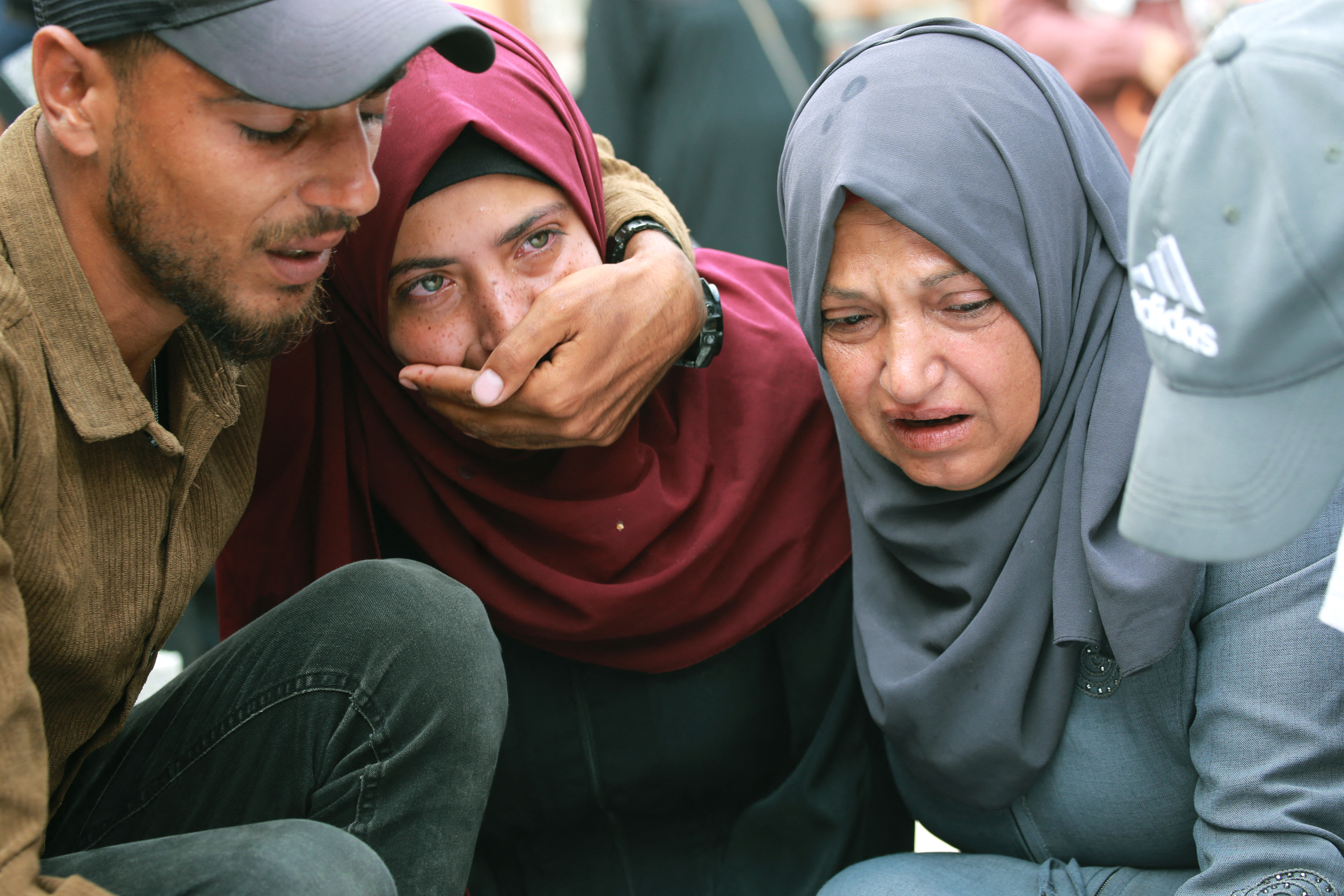 Palestinian women grieve as they bid farewell to a relative, killed the day before in a strike on the al-Mawasi camp, northwest of Rafah