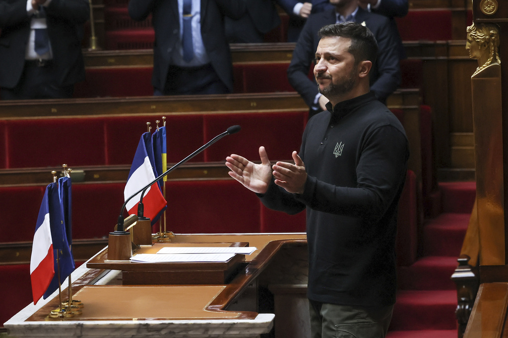 Ukrainian President Volodymyr Zelenskyy applauds after delivering a speech at France’s National Assembly, on June 7, 2024, in Paris