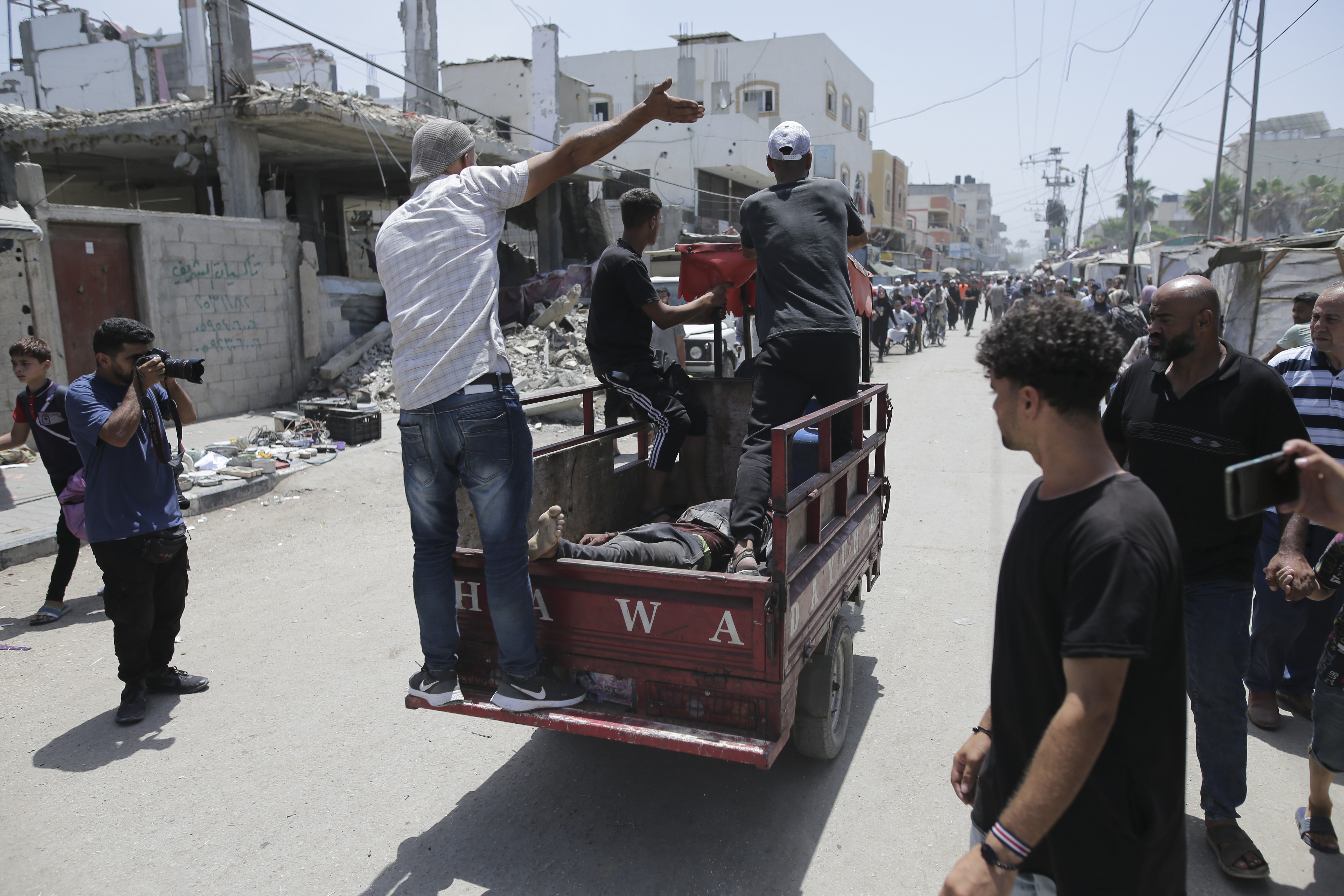 Palestinians evacuate dead and wounded in the Israeli bombardment of the Gaza Strip in Deir al Balah on Saturday, June 8