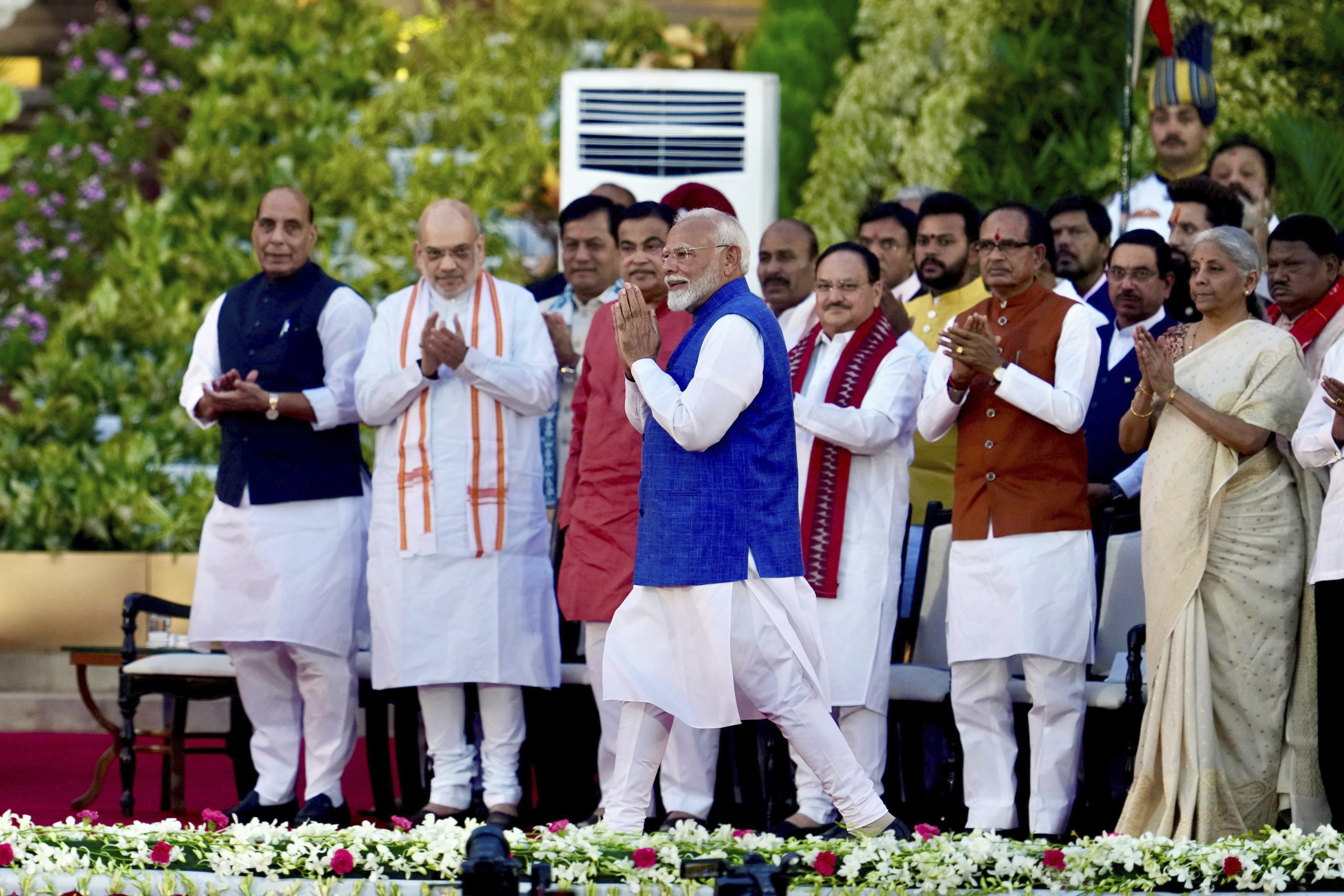 Narendra Modi greets the gathering as he arrives to take the oath as the prime minister of India at the Rashtrapati Bhawan, in New Delhi, India