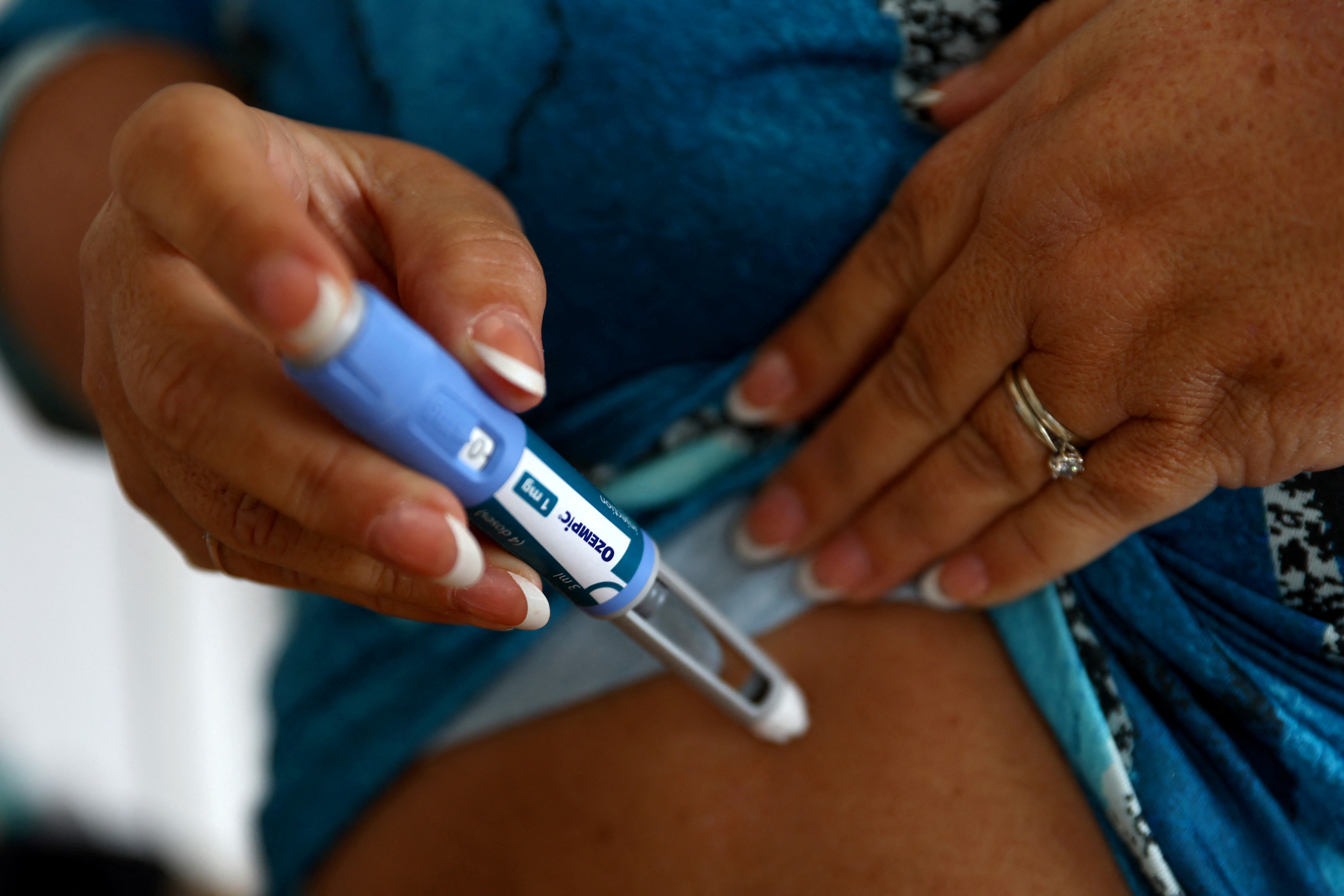 Kim Gradwell with an Ozempic injection needle at her home in Dudley, North Tyneside, Britain