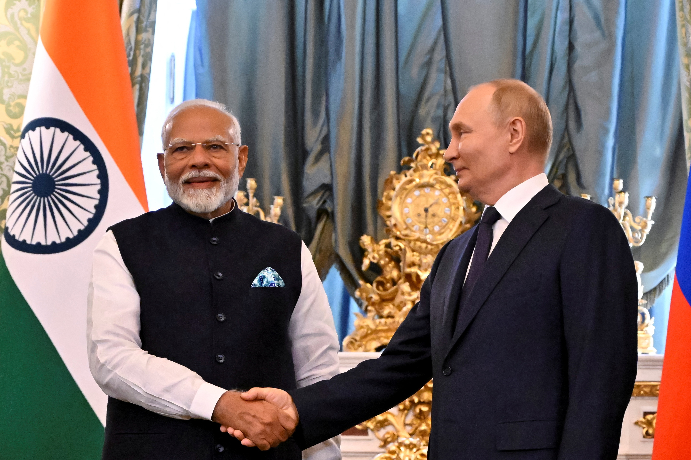 Russia's President Vladimir Putin shakes hands with India's Prime Minister Narendra Modi