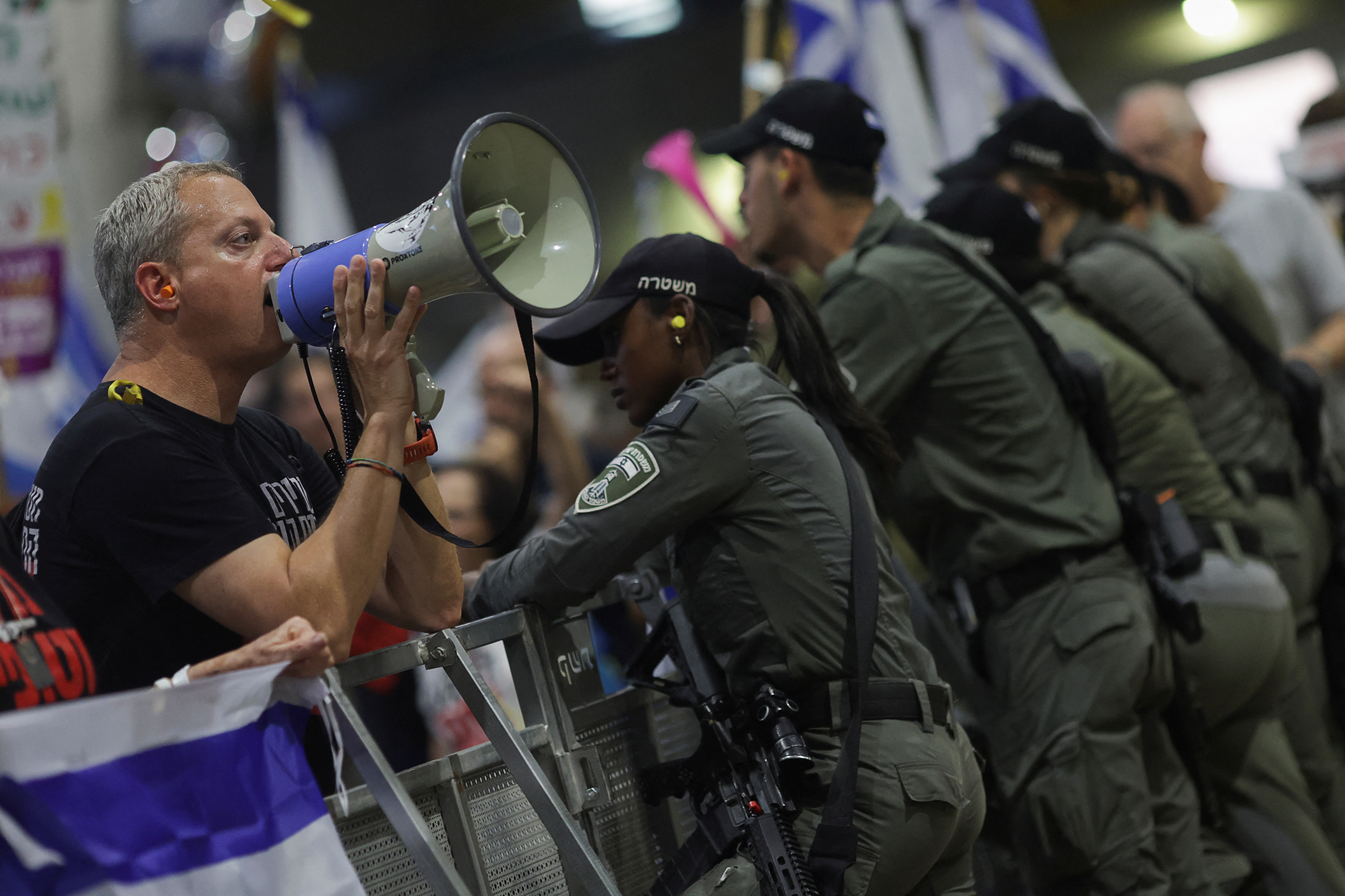 An anti-government protester at Ben Gurion Airport demonstrate against Israeli Prime Minister Benjamin Netanyahu's departure to the US in Lod, Israel, July 21, 2024. [Ricardo Moraes/Reuters]
