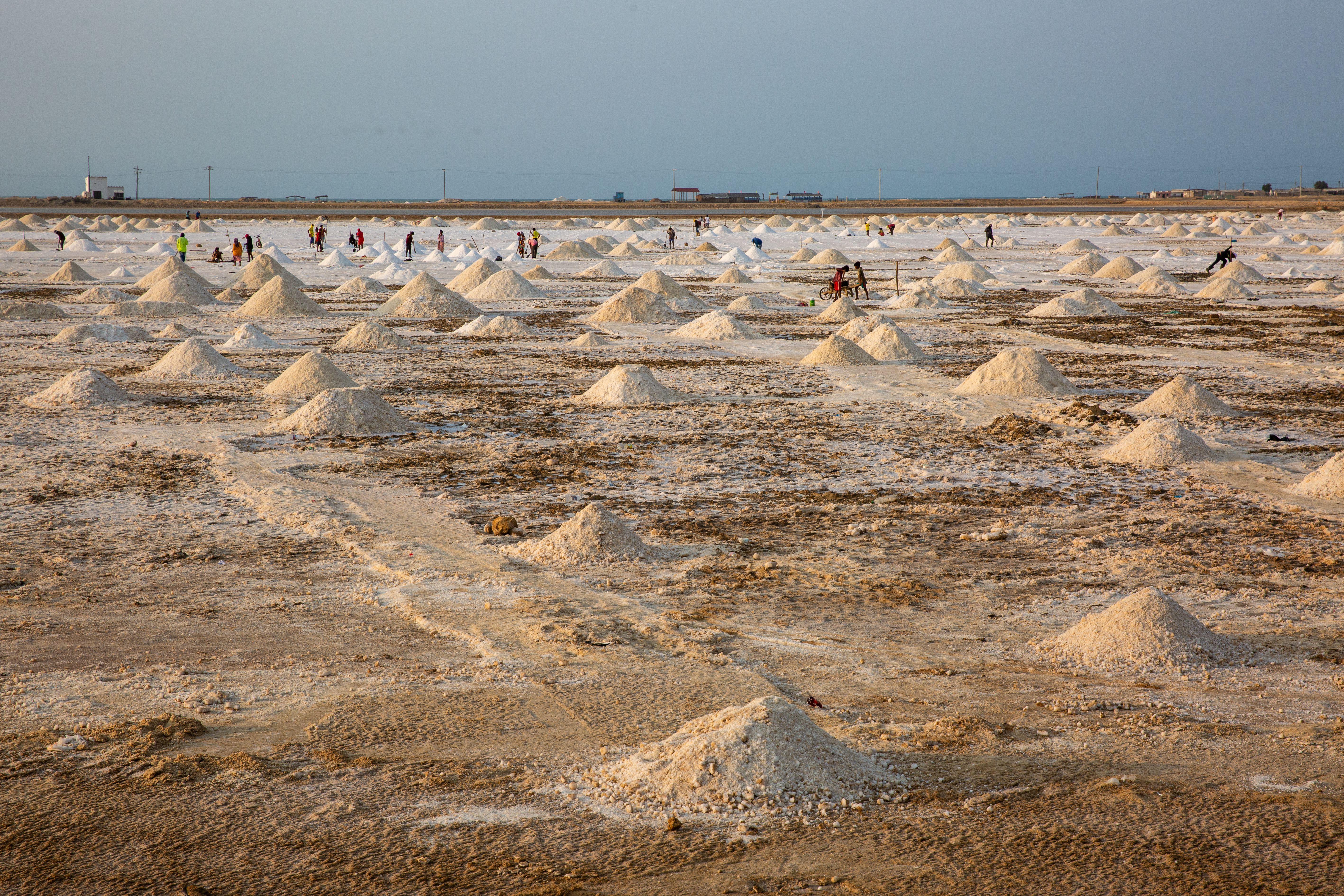 A field of salt, some piled into little pyramids.