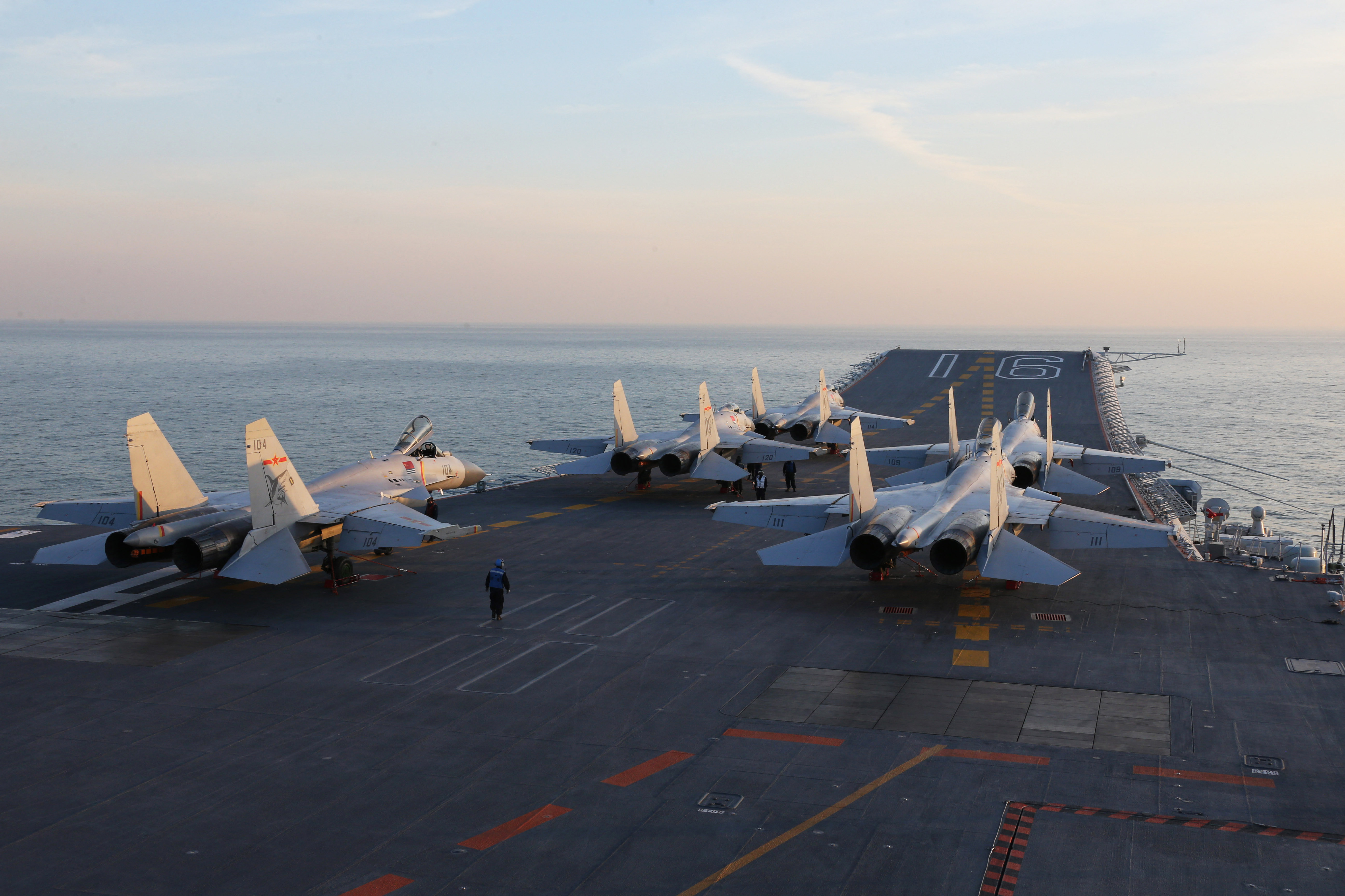 Chinese J-15 fighter jets waiting on the deck of China’s Liaoning aircraft carrier during military drills in the Bohai Sea, off China’s northeast coast in 2016 [AFP]