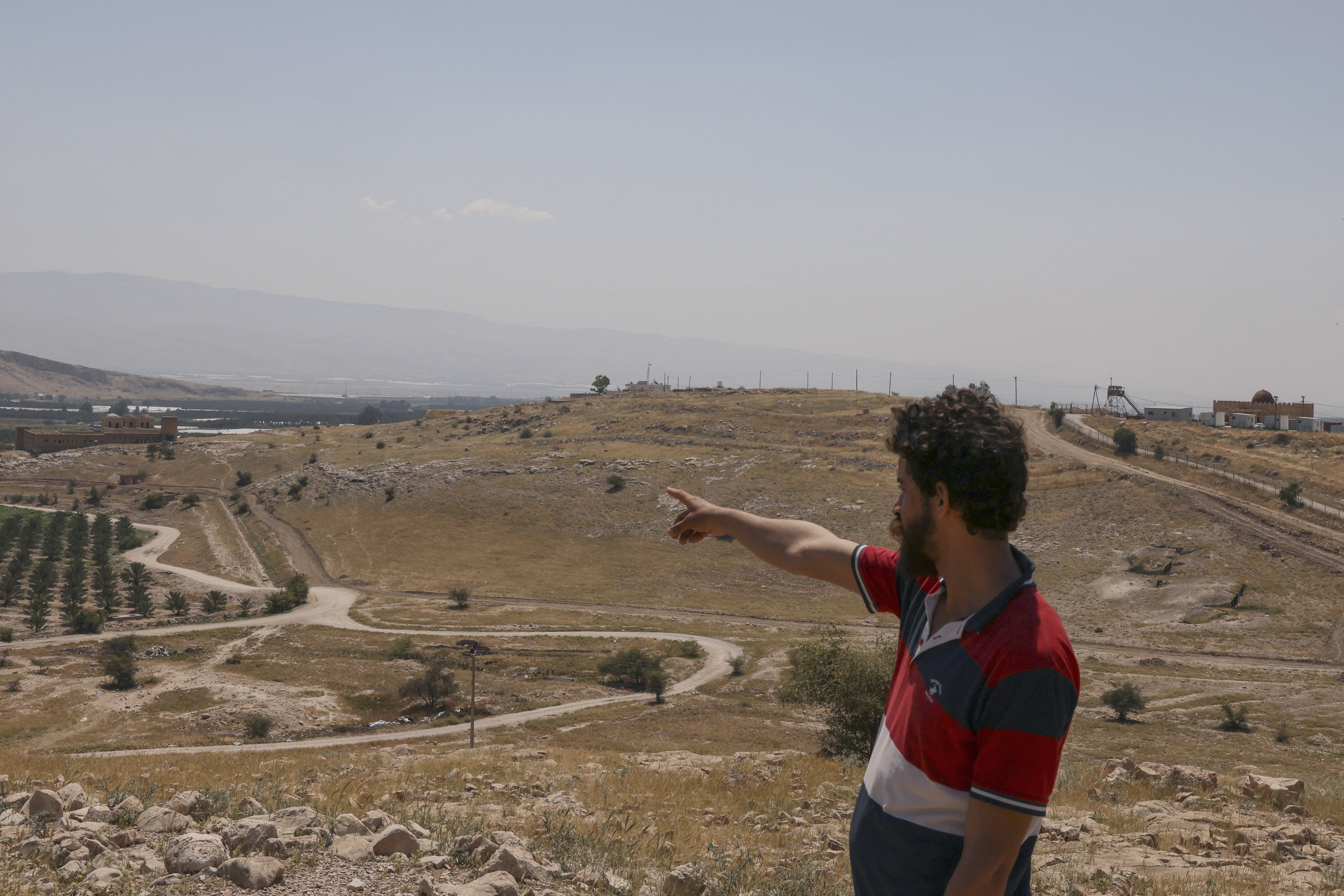 A villager points on April 16, 2024 towards a spot seized by the Israeli forces outside the Palestinian village of Jiftlik in the occupied West Bank, north of Jericho by the Jordan River. (Photo by HAZEM BADER / AFP)