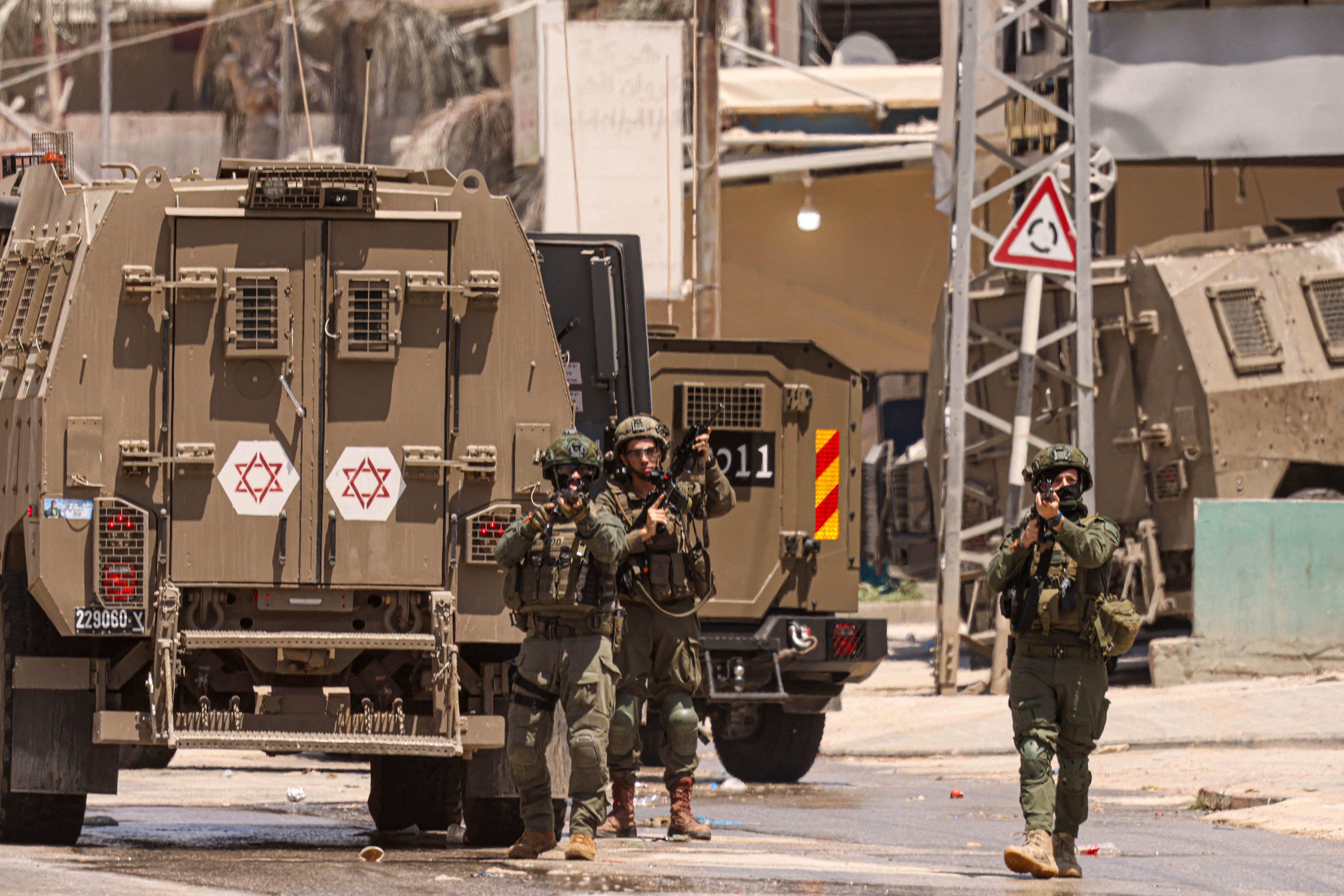 Israeli army soldiers take position during a raid in the Nur Shams camp for Palestinian refugees in the occupied West Bank