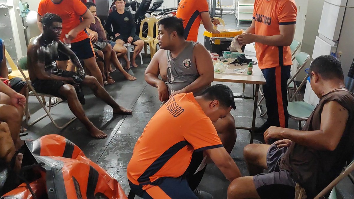 The rescued crew of oil tanker MT Terra Nova receive first aid on a coastguard ship off Manila Bay [Handout: Philippine Coast Guard via AFP]
