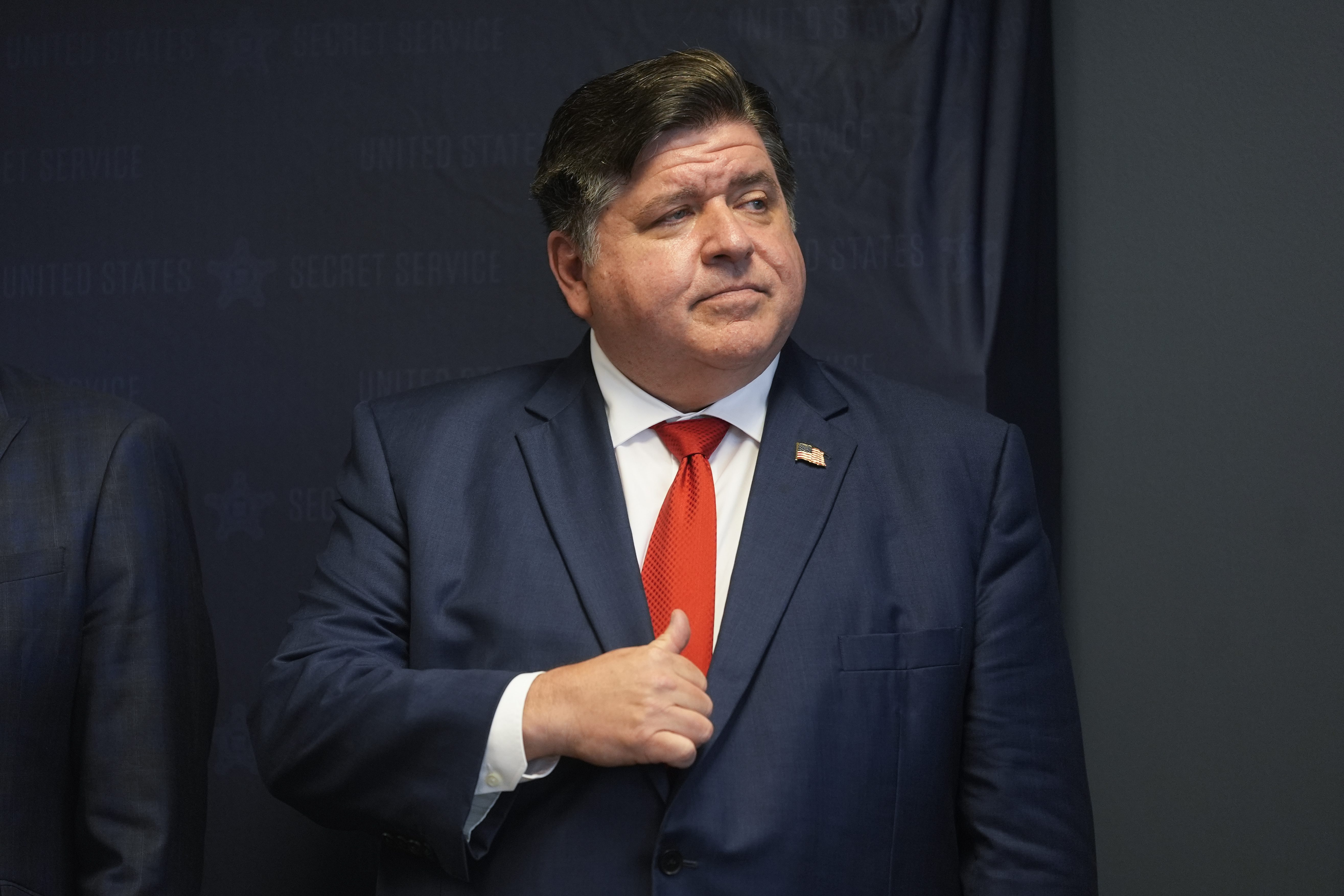 Illinois Gov. JB Pritzker speaks during a Democratic National Convention security briefing