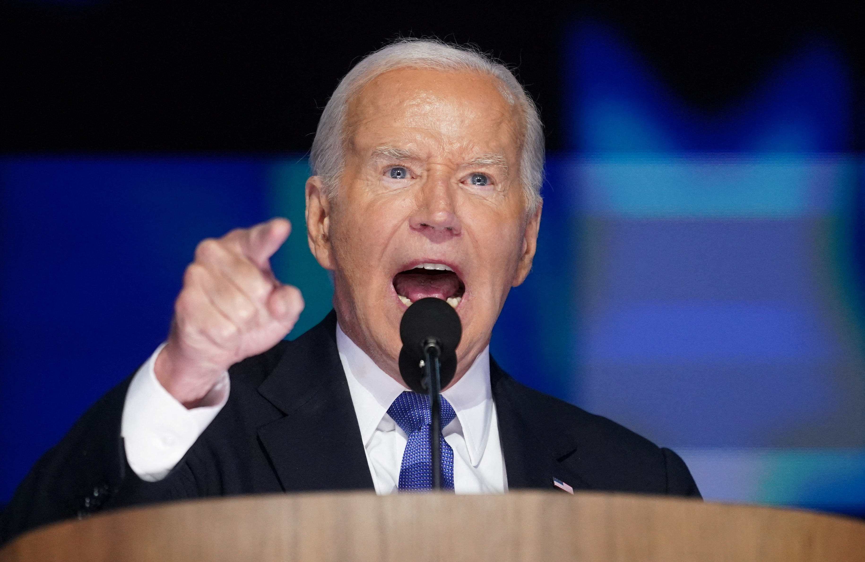 Joe Biden speaks into a microphone at the DNC