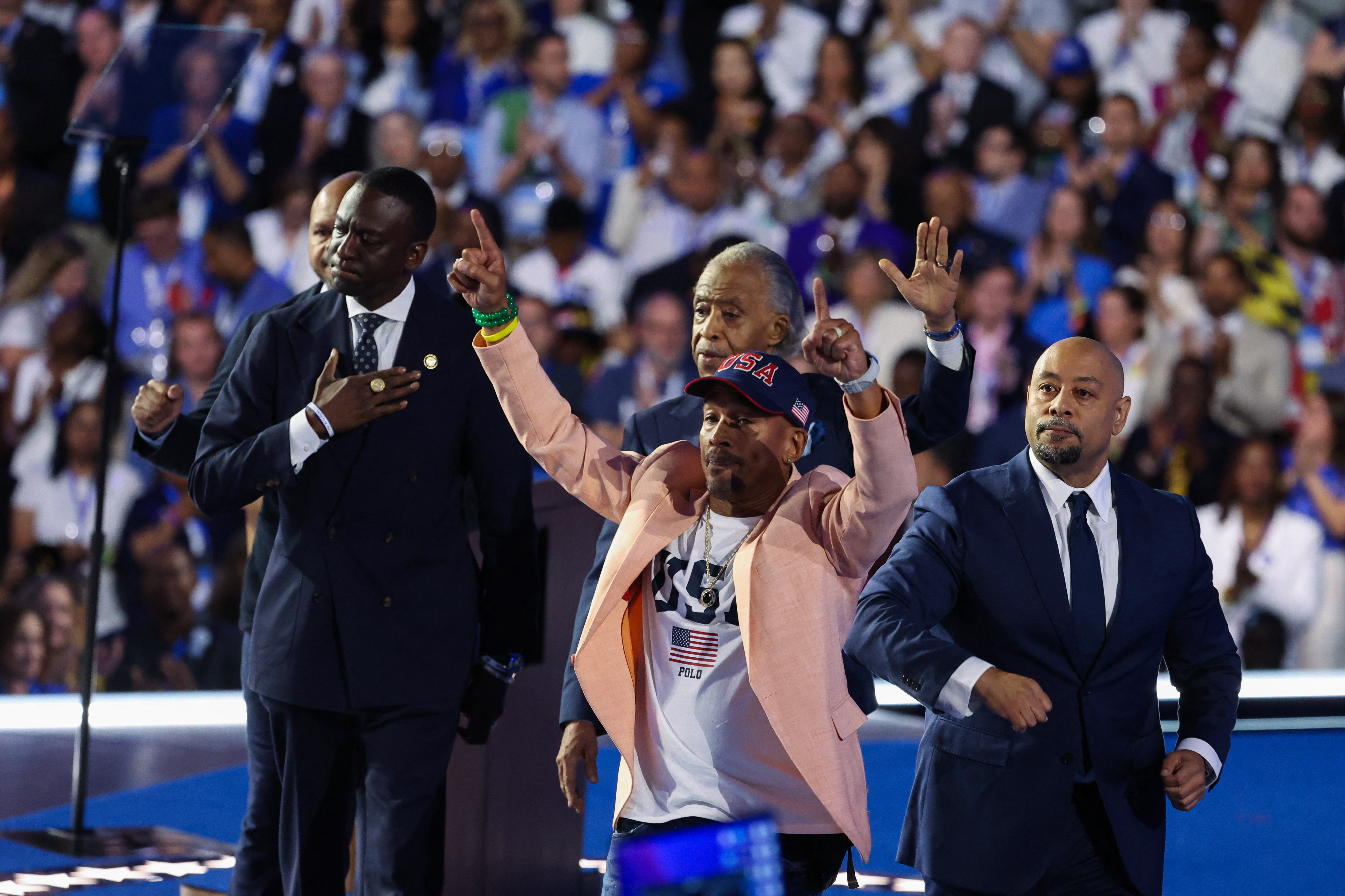 Reverend Al Sharpton walks on stage with Yusef Salaam, Korey Wise, Raymond Santana and Kevin Richardson, members of the Central Park Five, at the Democratic National Convention on August 22