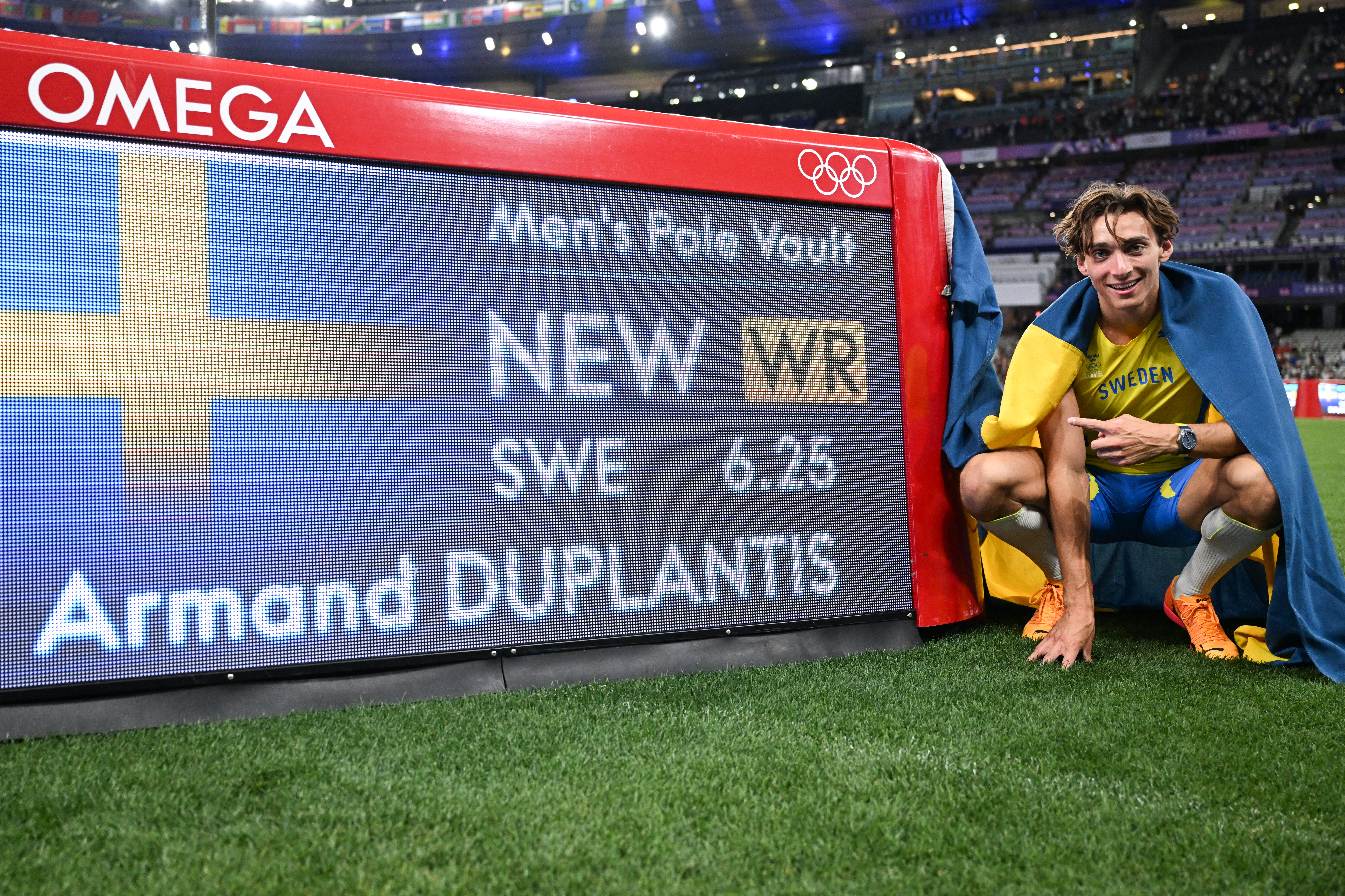 Athlete next to scoring display.