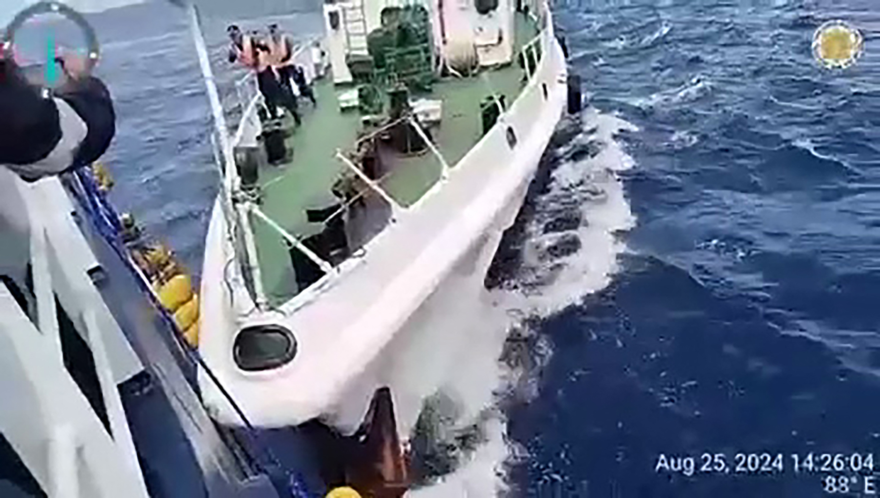 This frame grab from handout video footage taken and released on August 25, 2024 by the Philippine Coast Guard (PCG) shows a Chinese coast Guard ship (R) in a collision with the Philippine Bureau of Fisheries and Aquatic Resources (BFAR) vessel BRP Datu Sanday, near Sabina Shoal in disputed waters of the South China Sea. - China's coast guard said it rescued Filipino "personnel" who fell overboard August 25 after a Philippine vessel collided with one of its ships near a disputed shoal in the South China Sea, while the Philippine government accused Chinese vessels of ramming and using water cannon against its ship. (Photo by Handout / Philippine Coast Guard (PCG) / AFP) / -----EDITORS NOTE --- RESTRICTED TO EDITORIAL USE - MANDATORY CREDIT "AFP PHOTO / PHILIPPINE COAST GUARD (PCG) " - NO MARKETING - NO ADVERTISING CAMPAIGNS - DISTRIBUTED AS A SERVICE TO CLIENTS