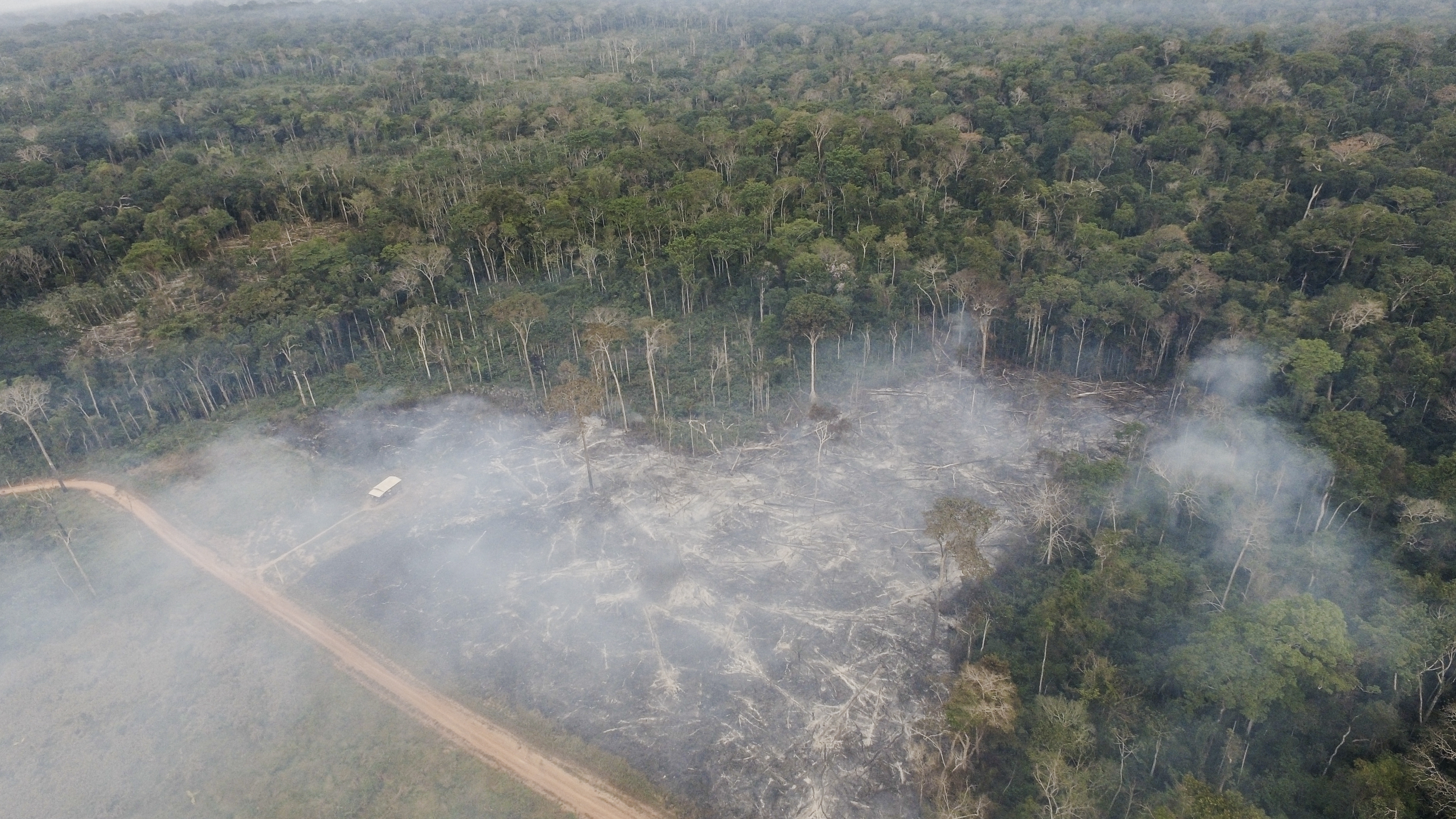 Smoke rises from fires in the Chico Mendes Extractive Reserve in Xapuri, Acre state, Brazil. Deforestation in the Amazon poses a threat to communities and health