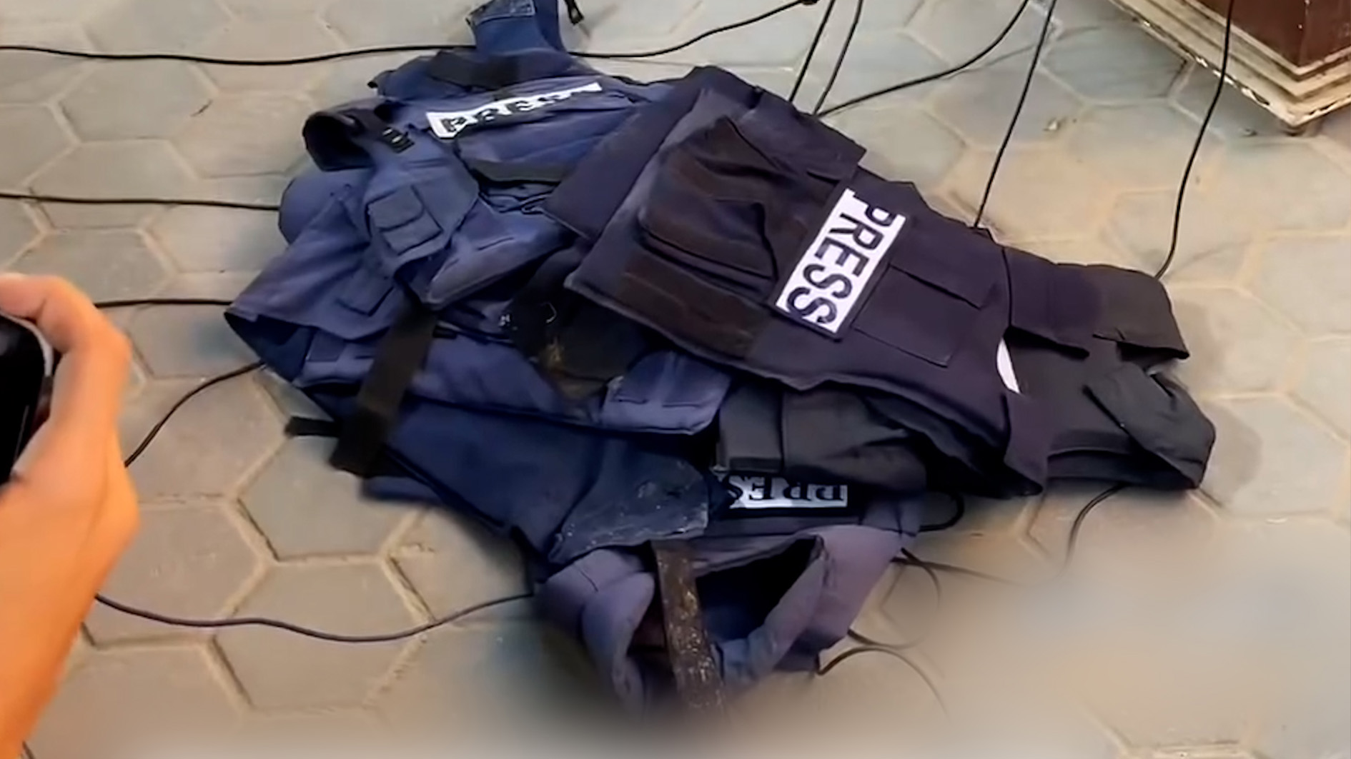 Press vests on the ground as Palestinian Journalists in Gaza protest the targeting of press and Al Jazeera colleagues.