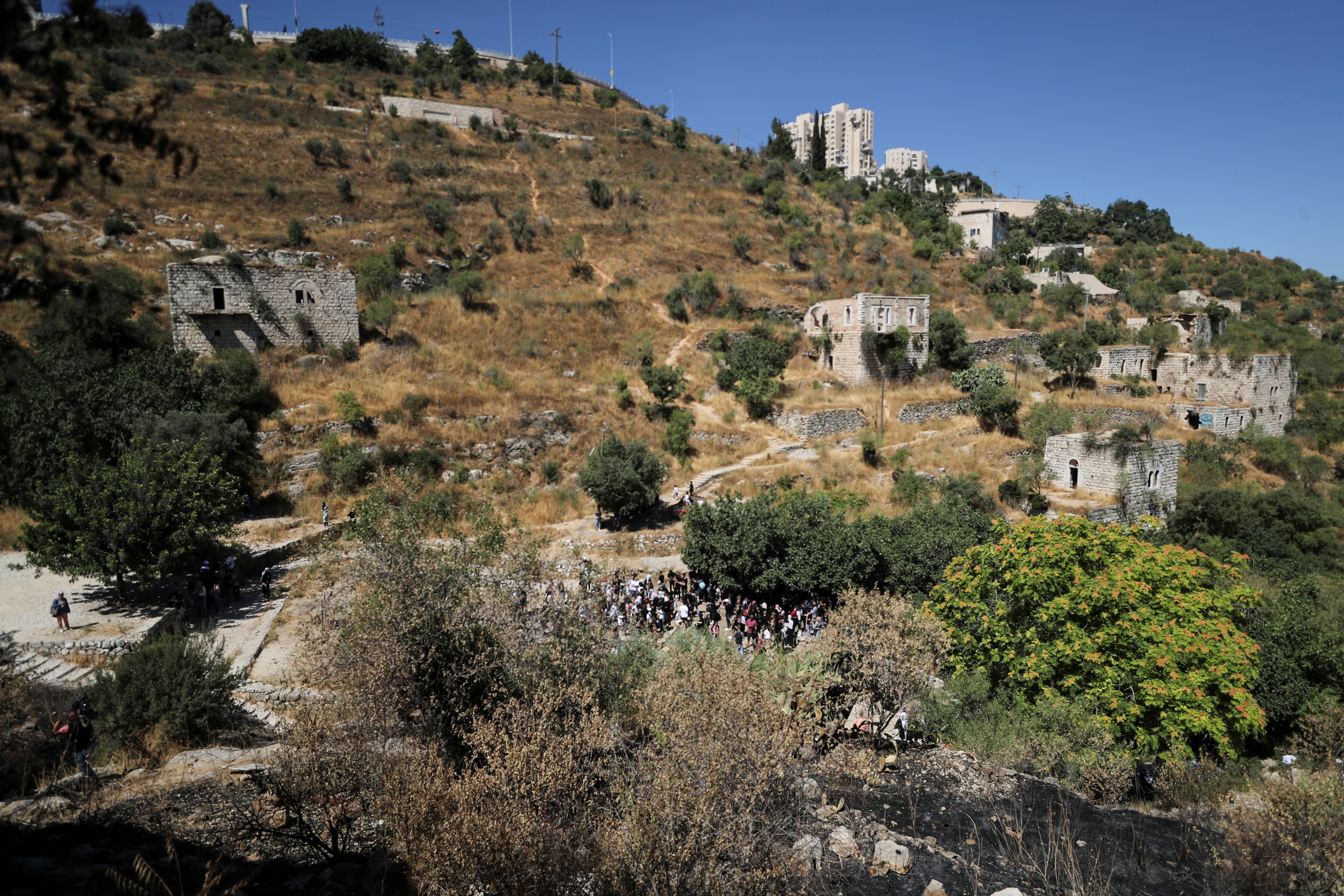 A general view shows a group of Palestinians visiting Lifta, a ruined Palestinian Arab village whose inhabitants left or were forced from their homes in the conflict that accompanied the end of British rule and the founding of Israel in 1948, in the outskirts of Jerusalem
